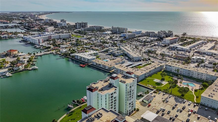 This stunning twelfth floor condo in the heart of St. Pete Beach delivers panoramic views of the Gulf of Mexico, the Bay, and Downtown St. Petersburg, offering a bright and beautifully furnished one bedroom residence that is fully prepared for immediate move in upon association approval. The displayed rent applies to lease terms of six months or longer, and shorter term stays under six months are available at a premium for those seeking a seasonal retreat. Inside, the spacious open living area extends into a flexible sitting and workspace, and the updated kitchen features porcelain tile flooring, light cabinetry with under cabinet lighting, generous counter space, and a pantry with roll out shelving. The bedroom is comfortable and inviting, while the spa inspired bathroom showcases porcelain tile walls, a walk in shower, and solid surface countertops. Additional features include hurricane impact windows and sliders with shutters, a newer HVAC system installed in 2021, excellent interior storage, and convenient laundry facilities on every floor. Three Palms Point is a guard gated waterfront community offering resort style amenities such as a heated waterfront pool, clubhouse, fitness center, sauna, billiards room, shuffleboard courts, and a private fishing pier, paddleboard and bicycle storage available. All of this is located just three blocks from the sandy beaches of St. Pete Beach and within minutes of the vibrant dining, museums, and cultural attractions of Downtown St. Petersburg, with Tampa and major airports only forty minutes away.