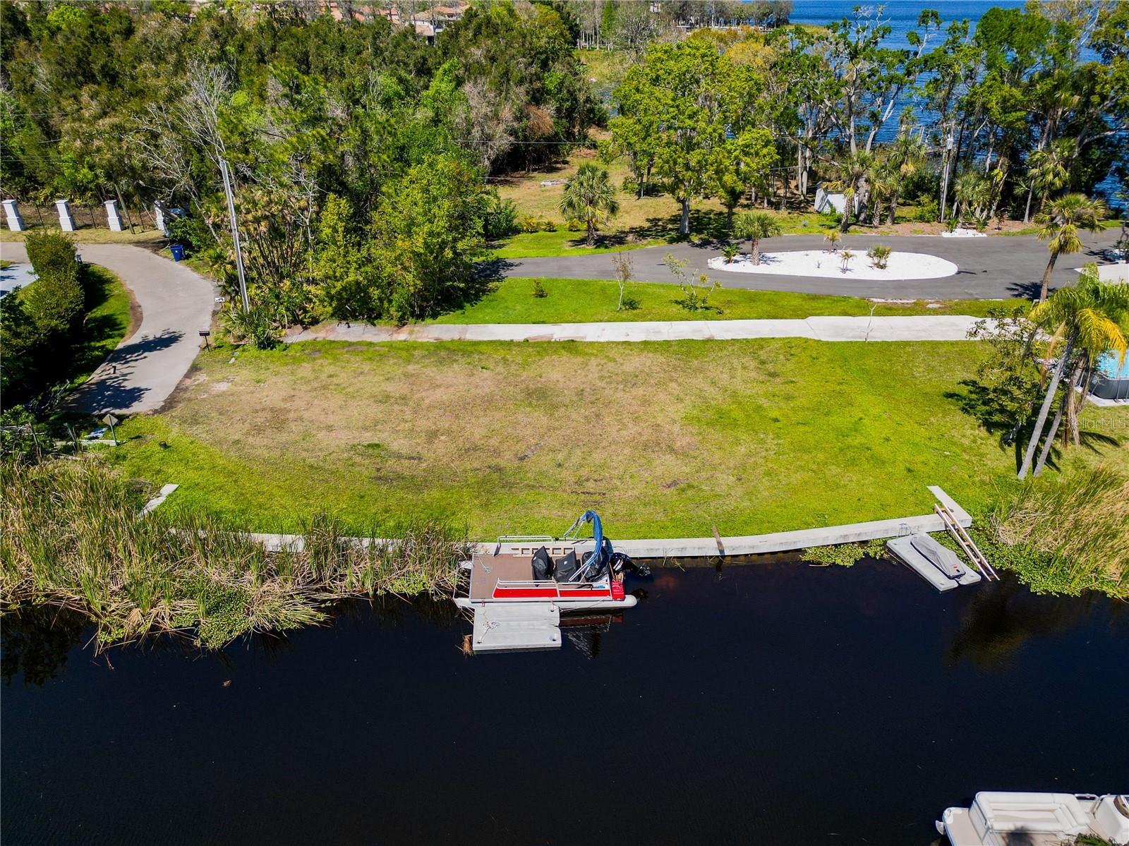 One or more photo(s) has been virtually staged. Now is your opportunity to Live and Play on Lake Tarpon! This large 105 X 60 waterfront lot is a beautiful spot to build the perfect home. A new concrete seawall has been re-built making this prime piece of land ready to go! This lot sits right at the end of the canal with quick and easy access to amazing and stunning Lake Tarpon. All Pinellas County Utilities right at the property line for easy hookup. The location couldn't be better-everything you need is close by including the new Trader Joes! Historic Downtown Palm Harbor as well as the famous Sponge Docks of Tarpon Springs are both just minutes away. The Virtual home photos are created to be similar to the home plans that are available upon request. Survey and soil samples available as well. Come visit your blank canvas today for waterfront dreams tomorrow! Watch our drone video: https://youtu.be/QKzm_iyqfdU?si=M-xPdn5fbZuqAIBG