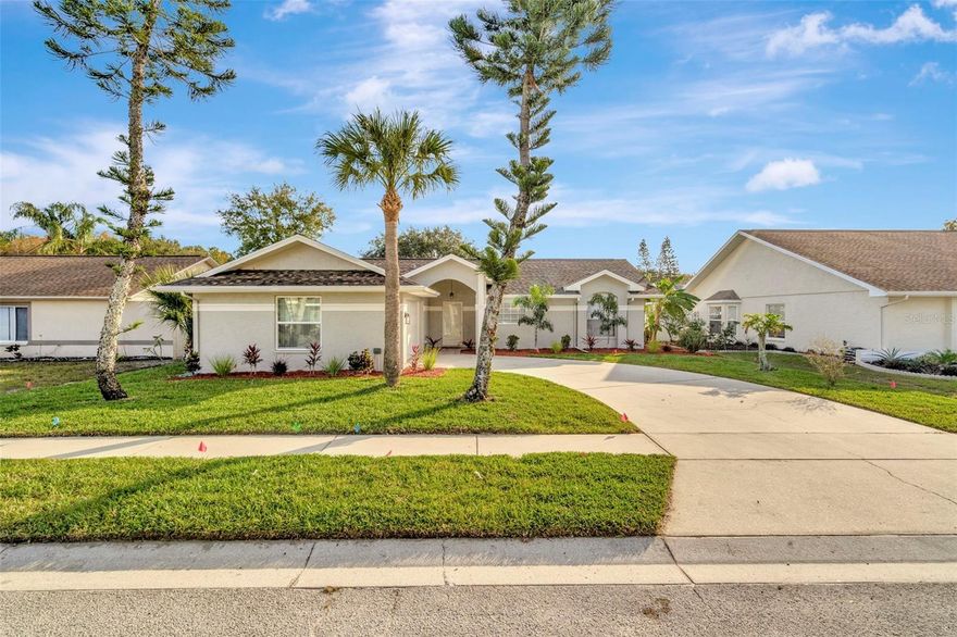 Don't miss this 3 bedroom and 2 bath open floor plan home with vaulted ceilings that looks brand new. Beautiful Gourmet chefs kitchen has white shaker cabinets, Quartz counter tops, stainless appliances, led recessed lights, crown molding and subway tile backsplash. The 2 large bathrooms have been redone from top to bottom (Quartz, marble, porcelain tile). Brand new roof. New ceiling fans and light fixtures thru-out. Grey distressed wood LVP flooring throughout entire living space. New Window Treatments, new 5 1/2" Baseboards, new 6 panel doors and hardware. Freshly painted inside and outside. Fresh landscape. Enjoy the bonus Florida room and covered screened Lanai on back of the house. Minutes to gulf beaches, shopping, dining, the Anclote fishing pier and historic Tarpon Springs. This one will not last!!