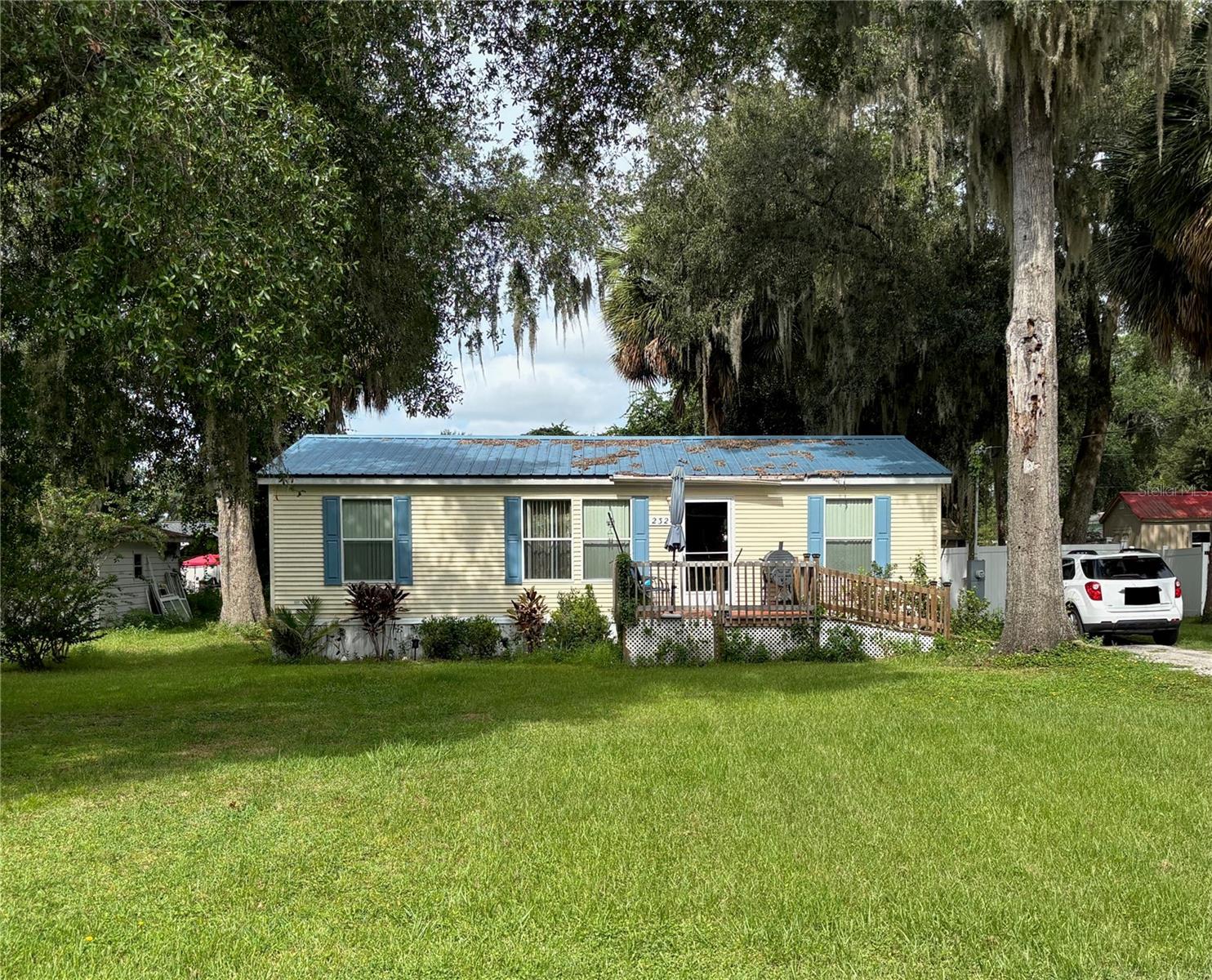 Jealous yet? You will be.
This stunning 3/2 split-plan 2003 double-wide manufactured home sits proudly on its own land—that’s right, no lot rent here. While others are stuck paying monthly fees, you’ll be enjoying exclusive resident access to North Lake, perfect for peaceful paddles or weekend fishing.
Dreaming of a Florida escape? This one’s already living the dream. Immaculately maintained by Mrs. Clean herself, this non-smoking home is move-in ready and comes fully equipped with all appliances. The charming black bear décor adds a cozy, rustic touch that’ll make your guests swoon.
Step out back to your vinyl-fenced yard—low maintenance, high privacy, and ideal for your furry companion. And yes, the seller is motivated, so a quick closing is absolutely on the table.
The envy doesn’t stop there:
• Roof replaced in 2020
• Full home update in 2020: new flooring, ceiling fans, fresh paint, and plush carpeting
• Front deck shaded by a mature tree, perfect for sunrise coffee moments
Nestled in a picturesque Florida-style neighborhood, you’re just 2 miles from groceries and shopping, and right on SR 40—your direct route to Daytona Beach and the iconic Silver, Alexander, and Juniper Springs.
If you’re into boating, fishing, or just living your best outdoor life, this location is pure gold. But hurry—homes like this don’t wait around. Someone’s Florida fantasy is about to come true… will it be yours?