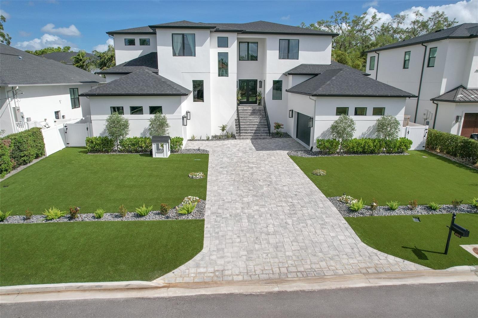 Stunning Luxury Home with Exceptional Upgrades and Resort-Style Living! Welcome to this exquisite, newly built residence where luxury meets comfort in every detail. Completed in 2024, this home spans an impressive 5,288 feet of living space and sits on a generously sized lot with a large front yard and meticulously landscaped grounds, creating an inviting and polished curb appeal. Inside, you’ll find 5 spacious bedrooms, 6 full bathrooms, and 1 elegant powder bath, all designed with exquisite finishes, custom trim work, and designer wallpaper thoughtfully selected throughout. With 10-foot ceilings on both levels, the home feels open and grand from the moment you walk in. At the heart of the home is the oversized great room, seamlessly connected to a gourmet kitchen—perfect for gathering and entertaining. Just off the main living area, a private bar room with French doors create a refined and intimate space for hosting guests in style. The butler’s pantry is an entertainer’s dream, complete with ample storage and a built-in sink. Upstairs, a large playroom/bonus room is the ideal space for entertaining, complemented by a dedicated laundry room. The primary suite, located on the main floor, provides a private retreat and features its own washer and dryer for added convenience. Outdoor living is just as impressive, featuring a beautiful outdoor kitchen that overlooks a sparkling swimming pool, ideal for relaxing, entertaining, or enjoying the Florida lifestyle. The home also includes a two-car garage with a separate single-car garage, offering ample space for vehicles and storage. A residential elevator provides easy access between the first and second floors. Located in the Plant District, this home features the perfect blend of elegance, functionality, and modern luxury—a true masterpiece that must be seen to be appreciated.