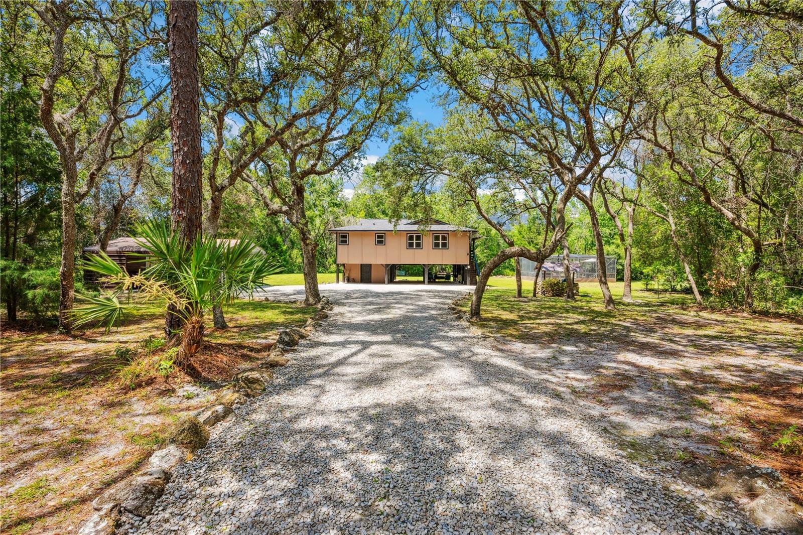 Escape to paradise with this stunning riverfront pool home nestled on 1.5 acres of serene beauty. Offering a vacation-like lifestyle, this well-maintained stilt home boasts a warm cabin feel with gorgeous wood flooring in the main living area. Offering a new roof in "2024", new 3 ton AC system & Well in "2023" & new water heater in "2022".
Enjoy breathtaking waterfront views from the screen-enclosed porch, or cast a line from your covered dock—perfect for fishing enthusiasts. Cozy up by the fireplace on cooler evenings, and take advantage of ample storage space, including an under-house workshop/storage room and a detached carport with storage.
Practicality meets charm with under-house parking, a brand-new roof, and complete privacy surrounded by nature. This unique property is ideal for those seeking peace, adventure, and relaxation all in one.
Schedule your showing today and embrace riverfront living at its finest!