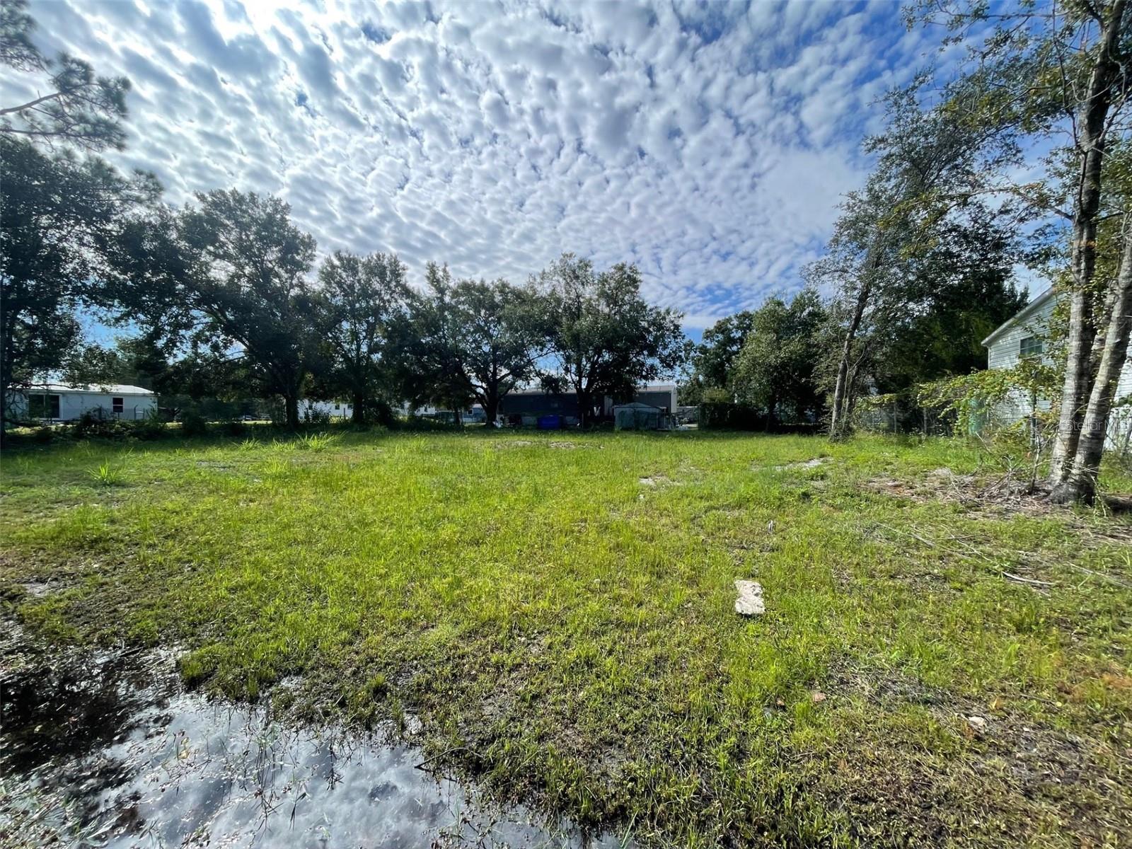 This property has 4 lots - 18-21 on which one can build or add a manufactured home fairly easily. The lot is cleared making the process easier. A few block south of SR 50 it has quick access to the beaches or Central Orlando. Create a rental income or build for yourself.