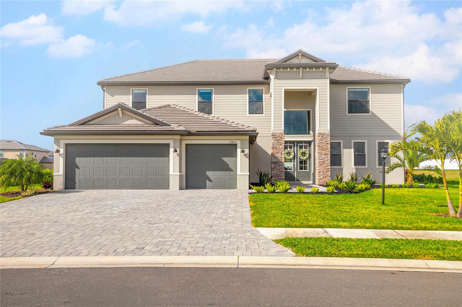 Seller is contributing with $15,000 towards closing cost!!!!!!! A newly customized home where luxury meets modern day style is for sale in the highly desired community of Lorraine Lakes in Lakewood Ranch. This 5 bedrooms, 4.5 bathrooms, den, office and 3 car garage is just a little over a year old. This gem is located on a cul-de-sac on a semi-private lot next to the preserve overlooking the pond in the rear. The house’s interior is 100% customized. The floors are tile throughout the entirety of the home. Upon entering this beauty, you encounter a 22’ high open foyer leading into the great room with a design made of natural stone. The kitchen overlooks the open great room with an 8-burner gas cooktop, wine cooler, soft closing ceiling height, natural wood cabinet doors and drawers, with an extensive amount of pantry space and a touchscreen refrigerator with views to the lanai and pond. Off the kitchen there is a half bathroom and a laundry room. To the right of the great room you’ll have a second master bedroom with sliding doors, walk-in closet, and full bath equipped with double sink and walk-in shower. The stair railing leading to the upper floor are of glass giving it an open space feel. The upstairs has laundry room for convenience. To the right you have the first master bedroom with 3 walk-in closets, and a double shower with bench and his and hers sinks. There are 3 additional bedrooms with built in closets and 2 full baths. The house has Hunter Douglas motorized window treatments throughout. The exterior has a customized outdoor kitchen with sink, BBQ, cooktop and a mini fridge. The 60’ wide spacious lanai is ideal for entertainment and overlooks the salted custom-made pool, spa with color changing lights and heater. The house includes a water filtration system and a separate filtration for the sprinklers. The amenity center offers a restaurant, pickle ball court, tennis court, basketball indoor and outdoor, gym, 2 pools, splash pad for kids and a playground.