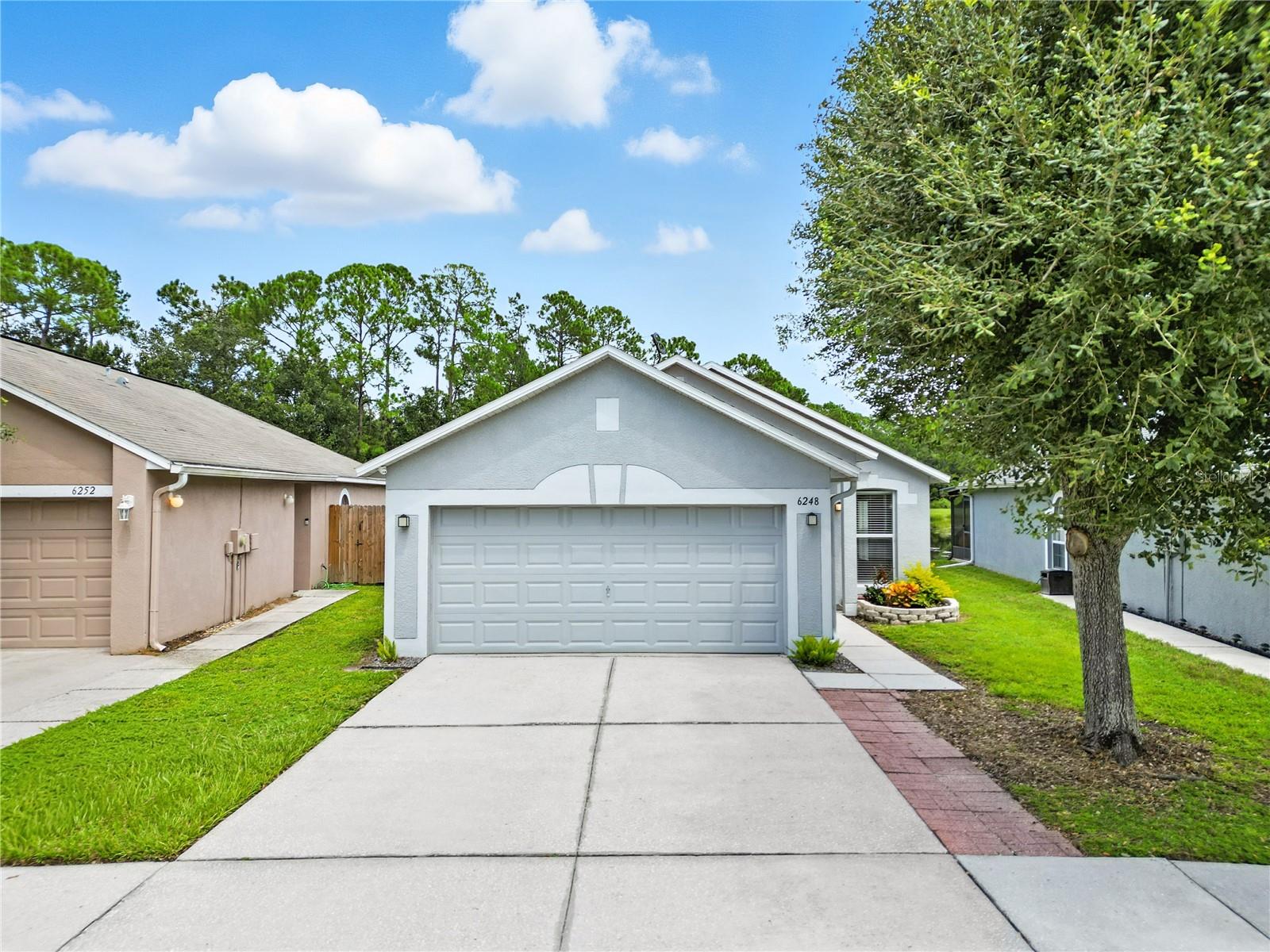Welcome to your dream home in the desirable community of Chapel Pines! This beautifully updated 3-bedroom, 2-bath, 2-car garage home offers a tranquil pond and conservation view setting with the perfect blend of comfort and modern style.
Step inside to an inviting open floor plan with vaulted ceilings and abundant natural light. The home boasts tile flooring throughout for durability and easy maintenance. Both bathrooms have been tastefully updated, while the remodeled kitchen (2022) features sleek cabinetry, matching appliances, and a bright island design—ideal for cooking and entertaining. Fresh interior and exterior paint add to the crisp, move-in-ready feel.The private owner’s suite showcases peaceful pond views with direct access to your outdoor retreat. Enjoy the covered, screened lanai or fish from your own waterfront deck while watching local wildlife. A fenced yard adds privacy, while sidewalks, streetlights, and low HOA fees enhance everyday living. Recent upgrades include a roof (2021), A/C (2019), newer garage door opener, and an attached 2-car garage with a Level 2 EV charging plug. All appliances are included. Conveniently located just 1.5 miles from elementary, middle, and high schools, and minutes from Wiregrass Mall, Saddlebrook Resort, local beaches, and major highways (I-75 & I-275).
This waterfront gem is truly turn-key and move-in ready—schedule your private showing today!