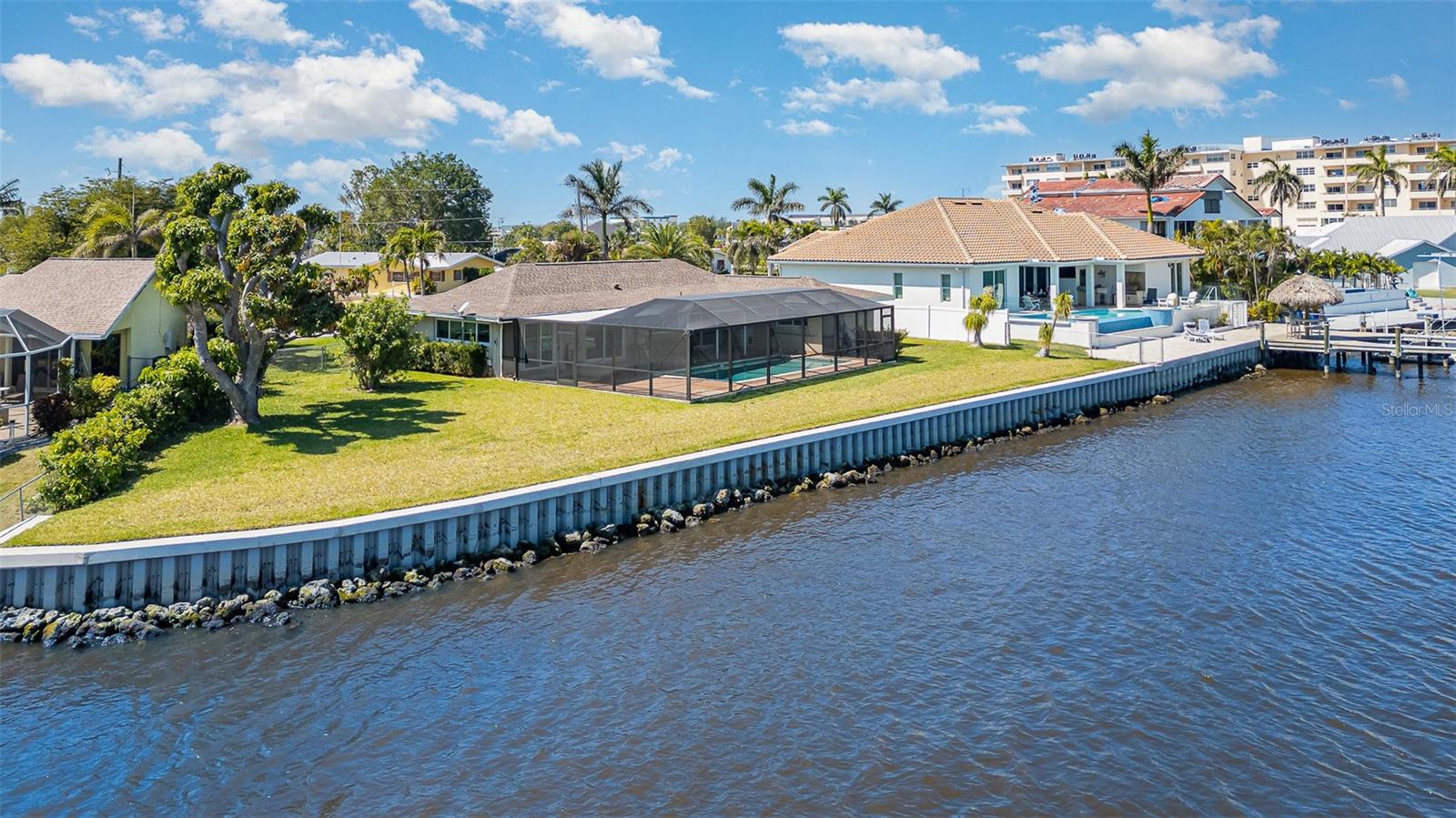 Outstanding Oversized Riverfront lot with Opportunity for Boaters & Investors. Being sold as LAND Value. Exceptional riverfront property offering approx. 150 ft. of frontage along the Intracoastal Waterway / Caloosahatchee River. Features a recently installed high-panel seawall with riprap, providing lasting shoreline protection and peace of mind. Enjoy a fenced yard with a mature mango tree, beautiful sunrise views, and moonlit reflections over the water. This property offers a front-row seat to the annual Red, White & Boom fireworks event, making it an ideal setting for entertaining or relaxing while observing local sea life.
The vibrant entertainment district is within walking distance, featuring restaurants, shops, city-hosted events, and a new food truck park with boat slips, fuel dock, bar, entertainment, and a ship store—perfect for an active boating lifestyle. Nearby airports, marinas, yacht clubs, and area beaches add further convenience and appeal. Take your boat directly from your backyard to explore waterfront restaurants, beaches, and barrier islands.
Neighboring parcels are also available (MLS# 225015665 & MLS# 225015699), presenting a unique opportunity for investors or those seeking to create an expansive riverfront estate. Located within the CRA District, offering additional development potential and incentives (verify with local authorities). Million-dollar water views and endless possibilities await. Southwest Florida lifestyle is calling. SW FL awaits you- What are you waiting for?
