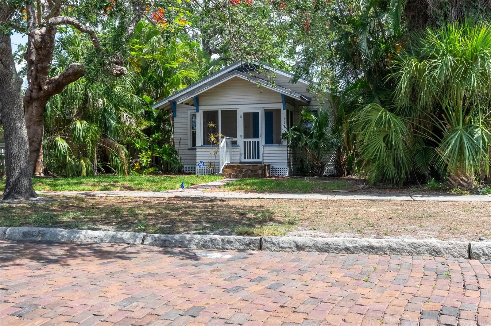 REDUCED Again! Location! Charming “Old Southeast” bungalow with a porch, situated on BRICK streets, just off 4th Street South - a Diamond in the Rough built in 1921.LARGE LOT measuring 50’ x 140’ with alley access. LOCATION! Located just under 1 1/2 miles from the center of downtown St. Pete, this property experienced mild storm damage in 2024. Following remediation, it is now available for you to either remodel or tear down and build a new home. This property is also listed as Residential #TB8394161; the buyer is responsible for any demolition costs.
Over 912 Square feet of living space includes: 3 bedrooms, 1 bathroom, hardwood flooring, a fireplace, central air conditioning (installed in 2020), a metal roof (installed in 2018), and an updated bathroom. Take a look at the photos along with the floor plan. https://visithome.ai/AqkewRcCAEwsCoUFEqjuP6?mu=m The property is being sold “AS IS,” and the seller will not make improvements. The current flood policy is TRANSFERABLE. Walk to the St. Petersburg Tennis Center, Lassing Park & Beach, Bartlett Park, and Salt Creek Marina, and it's just minutes to the University of South Florida, area museums, and downtown St. Pete is less than 2 miles away. Make the move to OLD SOUTHEAST!
