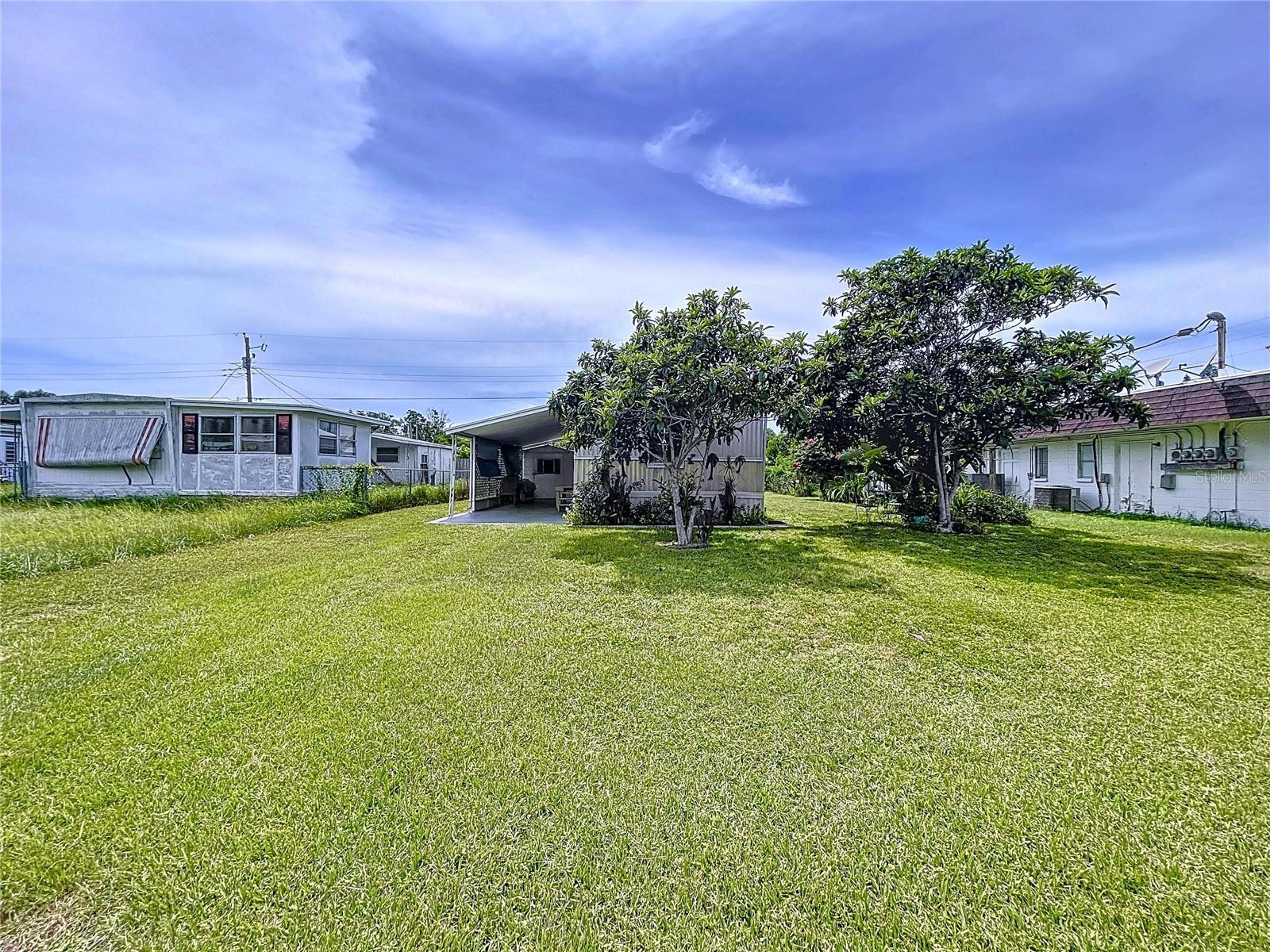 Affordable living in Dixie Groves Estates, Holiday! This 2-bedroom, 1-bath manufactured home sits on owned land—no lot rent and no HOA fees! Located in an all-ages community and not in a flood zone according to FEMA maps. With some TLC, this property offers great potential as a primary residence or rental. Features include laundry in the utility shed, a newer septic system (2006), roof last coated about 2 yrs ago, AC last replaced 5/2010, and a partially fenced yard featuring Loquat tree, bird of paradise and canna lilies. Conveniently located just 10 minutes from Pinellas County and about 25 minutes to the Suncoast Parkway for easy commuting.