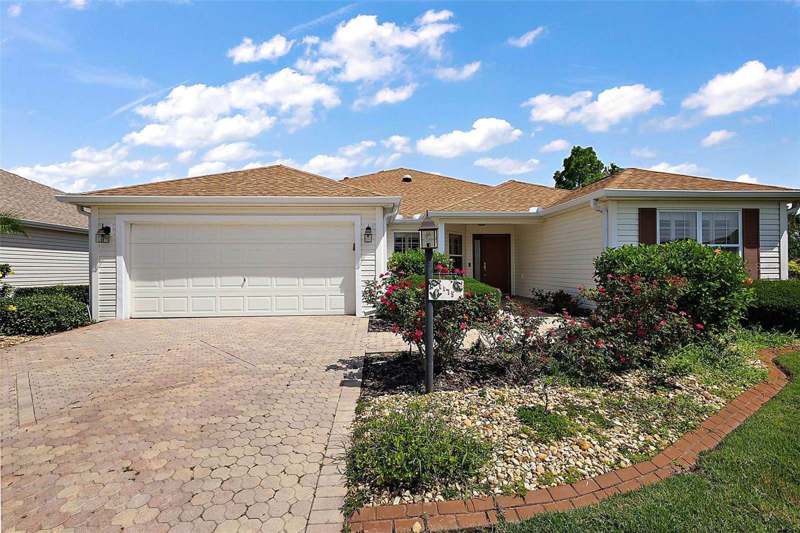 Welcome to 1175 Johnston Path, a beautifully maintained, expanded Camellia (Gardenia) model pool home in the highly desirable Village of Caroline. Perfect location, just six blocks from Lake Sumter Landing and just minutes from shopping, dining, and entertainment, including Aldi, Costco and Hobby Lobby.
This 3-bed, 2-bath home blends comfort and style with a long list of thoughtful upgrades. From the moment you arrive, you’ll be drawn in by the inviting curb appeal, featuring a paver driveway and walkways, mature landscaping, and flowering & fruit trees that create a lovely, welcoming entry.
Inside, the open split-bedroom floor plan features engineered hardwood floors, crown molding, plantation shutters, granite counters, and solar tubes for abundant natural light. The kitchen is both beautiful and functional, equipped with natural gas, a pantry, slide-out cabinet drawers, under- and over-cabinet lighting, accent lighting under the breakfast bar, and a newer refrigerator. The expansive living space flows seamlessly into the expanded Florida room, including a wet bar, which then leads you to your stunning saltwater pool with waterfalls. The pool is enclosed within a large birdcage and surrounded by privacy hedges and an impressive 12-by-75-foot patio, complete with raised garden beds, an ideal setting for entertaining, gardening or relaxing. Newer kitchen tile floor and light fixtures, and an upgraded 200-amp electrical panel add to the home’s thoughtful features. The primary suite is a peaceful retreat with double, spacious walk-in closets, dual vanities, and a step-in shower.
Additional highlights include a new water filtration system and water softener, 2018 HVAC system, a roof replaced in 2021, and pull-down attic stairs with extra insulation and decked storage space. Best of all, there’s NO BOND, offering added peace of mind and value. This move-in-ready pool home offers an incredible opportunity to enjoy the ultimate Villages lifestyle in an ideal central location, near 3 town squares. Don’t miss your chance to make 1175 Johnston Path your next home.