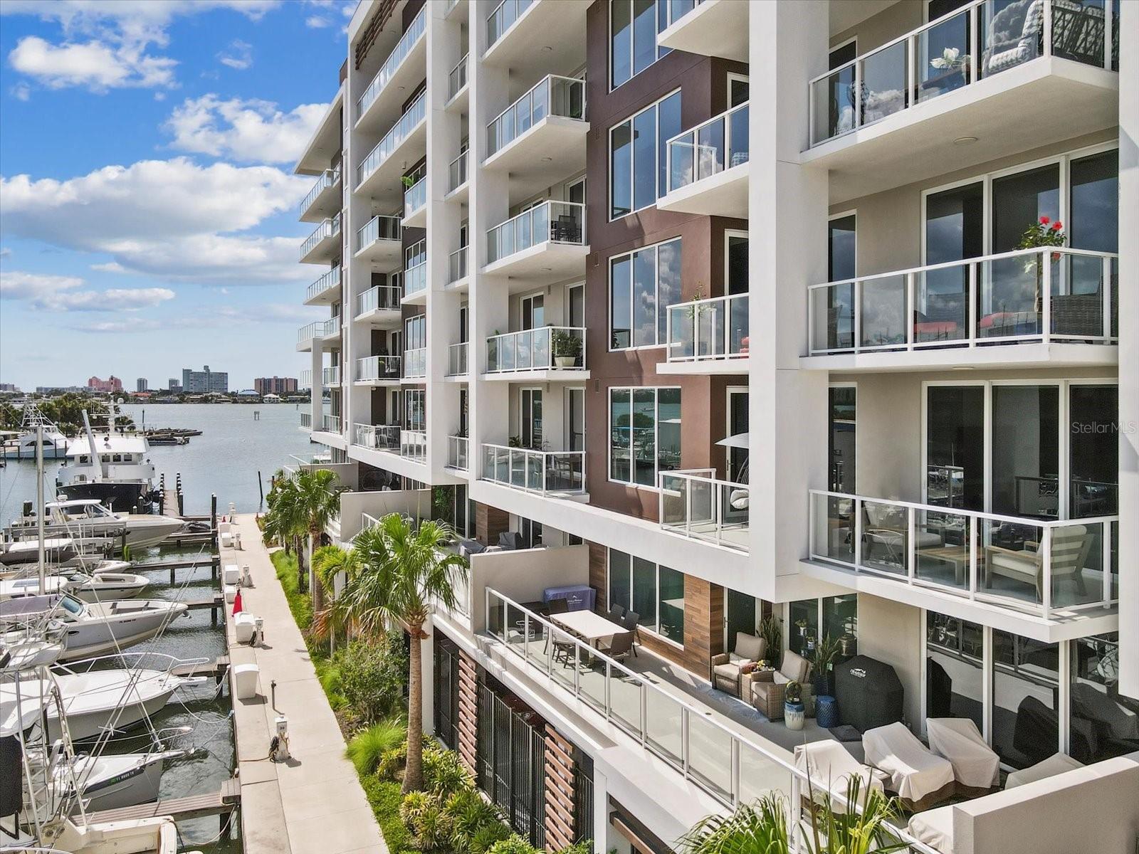 Experience luxury waterfront living in Marina Bay 880, a premier community on Clearwater’s Intracoastal Waterway. This 2 bedroom condo includes a spacious den/office, perfect for work or additional living space, and features an open layout with elegant finishes. Enjoy serene water views from the 216 sq ft balcony with glass railings. The kitchen offers wood cabinetry, quartz countertops, a center island with seating, and upgraded flooring. The primary suite includes dual walk in closets, a generous bath, and a walk in shower with dual shower heads. Remote control blackout blinds in both bedrooms and light filtering shades in the living area are included, along with hurricane impact windows and doors, upgraded lighting, and a climate controlled storage unit.
Marina Bay 880 provides resort style amenities including a 25 meter lap pool with sun shelves, hot tub, outdoor fire table, grilling and dining areas, putting green, full service marina, sauna, steam room, fitness center, clubroom, gated garage parking, EV charging stations, bike racks, and kayak storage. Ideally located minutes to Clearwater Beach, Dunedin, Honeymoon Island, Belleair, and St. Petersburg with easy access to Tampa International and St. Pete Clearwater airports.