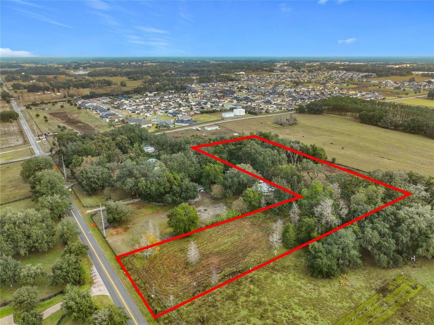 Discover the perfect blend of privacy, convenience, and flexibility with this exceptional 5-acre vacant land opportunity in Oxford, recently annexed into the City of Wildwood. Tucked away as a flag lot, this property offers a remarkably private setting with a partially cleared homesite already in place. The seller has building plans available, and a survey is on file for added peace of mind.  Enjoy the freedom to build exactly what you want with no deed restrictions and no HOA. You may choose to install your own well and septic or connect to city services. Despite the tranquil, secluded atmosphere, this property is ideally located with easy access to I-75 and is just minutes from dining, shopping, entertainment, and medical facilities in The Villages.
Whether you're ready to build now or invest for the future, this rare acreage offers endless potential in a highly desirable location. Call today for your private showing!