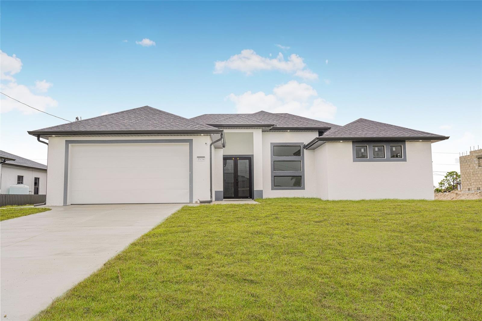 One or more photo(s) has been virtually staged. Seller is offering $10,000 toward buyer’s closing costs, making this home even more attractive!
Stunning Modern New Construction in Cape Coral! Never before lived in, this home combines contemporary design, high-quality finishes, and exceptional attention to detail. Featuring 3 bedrooms, 2 bathrooms, and a versatile den, the open-concept living, dining, and kitchen area is flooded with natural light and stays comfortably cool all year.
The primary suite boasts dual walk-in closets and a luxurious en suite bathroom. The gourmet kitchen comes fully equipped with brand-new appliances, while the laundry area includes new washer and dryer, so everything is ready, no need to purchase anything.
Enjoy the spacious island, ample storage with pantry, and sleek porcelain tile floors throughout. Step outside to the patio/lanai, perfect for relaxing and entertaining in Cape Coral’s beautiful weather. Additional highlights include a 2-car garage, landscaped yard with irrigation system, and thoughtful modern touches throughout.
Property is located in FEMA Flood Zone AE. Seller has a current Elevation Certificate confirming compliance with floodplain requirements. Buyer is encouraged to review flood insurance needs and conduct any desired inspections. This home offers peace of mind with its certified elevation and quality construction.
Ideally located near schools, parks, shopping, and amenities, this home is perfect for families or anyone looking for a move-in ready modern home. Walkthrough video available here: https://www.youtube.com/embed/oFYToeD4nV8