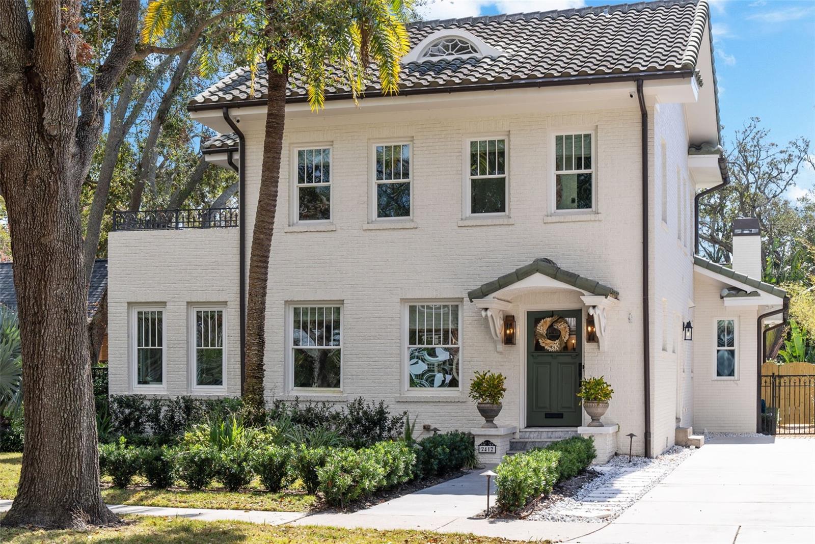 Perfectly positioned on one of the prettiest streets in Tampa awaits your new home. This stunningly updated beauty is like no other. As you approach the three-story brick masterpiece, look around at the street replete with a gorgeous canopy of trees creating an idyllic setting. Note the sidewalks for evening strolls and expansive front yards for extended play. Step inside the front door to note the rare combination of historic charm with modern finishes. There is exceptional millwork, wide plank oak floors, high ceilings and beautiful light fixtures creating an impressive setting. To your right, travel up a flight of stairs to three secondary bedrooms and two full baths. You will also find. 3rd floor bonus nook. It’s the perfect spot for watching movies, curling up with a good book or playing games. Back on the first level, the foyer opens to a formal living space with decorative fireplace. Walk through the brick lined archway to the sun porch, the perfect space for an office. Another brick lined archway leads to your formal dining room. The kitchen is a chef’s dream! The focal point is a gorgeous La Cornue gas range but there is so much more to appreciate! The oversized island with storage and marble counters are the perfect spot for informal meals. All the cabinets are handcrafted and designed specifically for the home. The marble counters continue to a partial backsplash which meets a beautiful ceramic subway tile leading to the ceiling. There is a hidden working pantry and more storage under the stairs. For those who love to entertain, there is a stunning wet bar with marble counters, antique glass backsplash, a built in Miele coffee maker, an ice maker and beverage fridge (all behind cabinet panels for a seamless sightline). The kitchen opens to an oversized family room with a cathedral ceiling. Want to take the party outside? Open your wall of sliders and step onto your screened lanai. There are brick pavers, plenty of space to relax and a wood burning fireplace for cool evenings. When it’s warm, enjoy a dip in your saltwater pool or soak in the spa. It is all possible here! Back inside, retreat to the primary suite with stunning ceiling millwork and light fixture. It is a great escape! There are two walk-in closets and ample space for furniture. The bathroom offers beautiful marble tile, separate vanities, tall cabinets, a vintage claw foot tub and walk in shower. Beyond the primary, there is a large laundry room with marble counters and custom cabinets. There is also a beautiful powder bath with close entry from the pool. The drop zone by the two-car garage is enviable with 4 cabinets and deep drawers for shoes. Up the back staircase, find a guest retreat. There are two rooms, each with closets (for a 5th and 6th bedroom if needed), a full bath and wet bar. Other features include a long drive way for additional parking in the front and an automatic gate off the back for garage entry. Zoned for A rated schools (Mitchell, Wilson and Plant), close to downtown Tampa, and Tampa International Airport. Schedule your showing today!