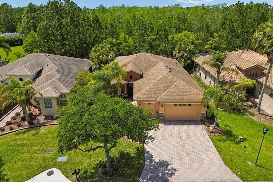 One or more photo(s) has been virtually staged. Welcome to this Boca Raton model in a quiet neighborhood near the Palms Resort amenities center, situated on an expansive conservation lot. This 2-bedroom, 2-bath home with a dining room and den/hobby room offers an open, inviting, and relaxing place to enjoy life. Upon entry, you will immediately notice how the living and dining spaces are filled with natural light, creating a bright and cheerful atmosphere that makes these favorite gathering areas even more welcoming.  Throughout the home, you will find tasteful upgrades and thoughtful design details, including upgraded lighting, ceiling fans, crown molding, wood flooring, ceramic tile, and plantation shutters and a central vacuum system. The chef’s delight kitchen is beautifully appointed with modern, upscale finishes such as tile backsplash, granite countertops, upgraded stainless steel appliances, a double oven, a charming breakfast bar, and a dining nook with a lovely view. The living area features crown molding, elegant plantation shutters, upgraded ceramic tile, and more. As you move from room to room, you will discover something to appreciate at every turn. The spacious Owner’s Suite feels luxurious, and the en-suite bath includes an upgraded glass-enclosed shower and dual sinks. From the Owner’s Suite, you also have easy access to the lanai. Enjoy peaceful moments on the large, enclosed screened lanai with a lush tropical view. A fenced side yard with pavers expands your outdoor living space and offers even more room to relax and entertain. The second bathroom features an accessible, highly rated Liberation walk-in tub, making bathing easier and safer for all ages. The laundry room includes ample cabinetry and a utility sink for added convenience, and the 2-car garage plus golf cart garage features a custom built-in cedar closet, perfect for safely storing your special garments. Solivita is a premier 55+ community, offering residents an exceptional lifestyle with state-of-the-art amenities. Enjoy a fully 2 equipped fitness centers, dance and aerobics studios, and an impressive array of recreational options including 14 heated swimming pools, two heated spas, tennis courts, pickleball courts, shuffleboard, bocce ball, billiards, and an art gallery. The community also features three on-site restaurants and two championship 18-hole golf courses. With a full calendar of activities and events, there’s always something new to explore and enjoy. This home is conveniently located near a hospital and medical office complex, and shopping center.