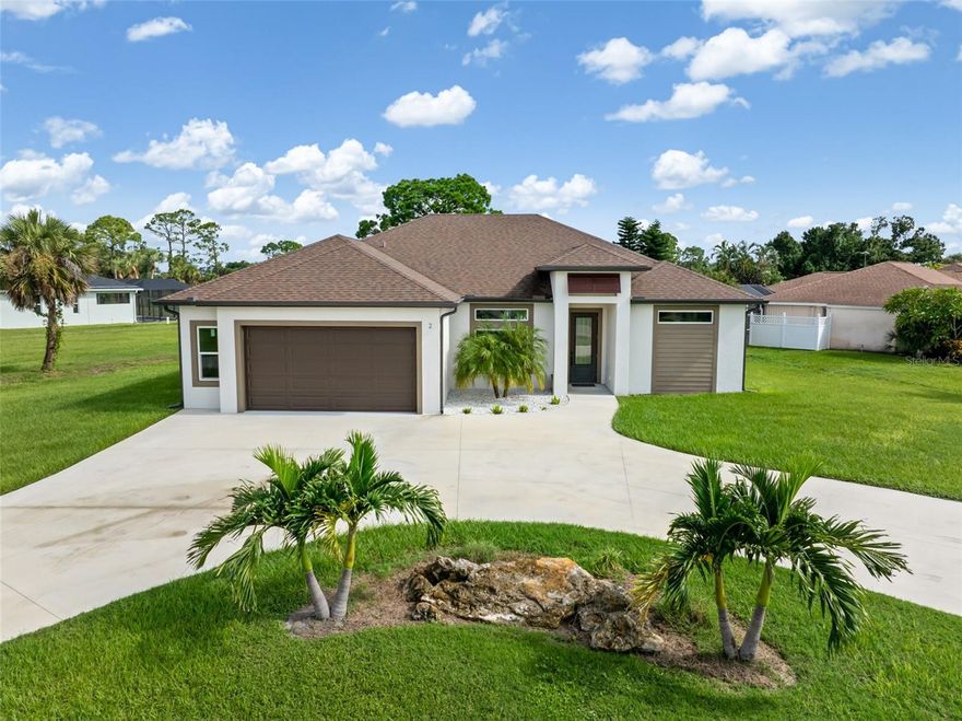 Modern elegance meets Florida lifestyle in this stunning 3BR/2BA + Den POOL HOME on an oversized corner lot in Rotonda West! Built in 2021 and located in an X flood zone (no flood insurance required), this custom home features hurricane-impact windows/doors, tray ceilings, upgraded flooring, and a chef’s kitchen with SS appliances and a custom granite island. The open split floor plan offers oversized bedrooms, wide hallways and a spacious den. Enjoy sunset views over the lake from your saltwater pool and huge pavered deck. Lanai includes gas hookup—ideal for an outdoor kitchen. Oversized garage offers extra storage. Low HOA ($190/year). Short-term rentals allowed in this golf community with 99 holes across 5 courses, plus parks and pickleball. Minutes to beaches, bike trails, dining & shopping. Florida living at its best!