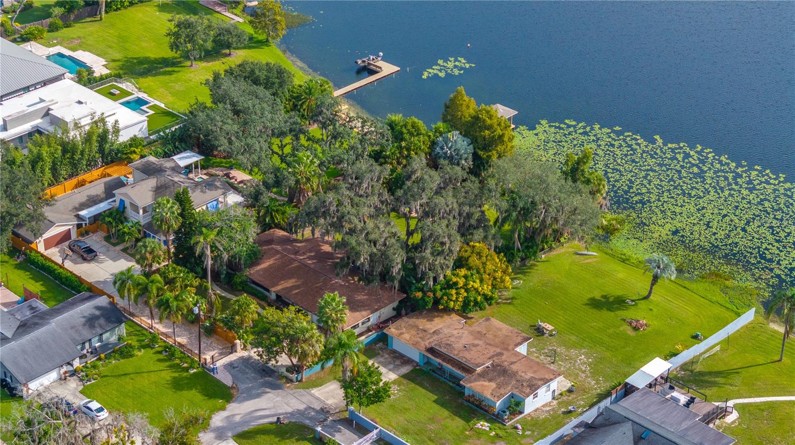 Perfectly positioned on the tranquil shores of Lake Seminary, this beautiful home offers the ultimate lakefront lifestyle in the heart of Maitland. From the moment you arrive, the home’s refreshed landscaping and elegant façade set the tone for what awaits inside. Step through the doors and you’re greeted by open living spaces accented by engineered hardwood floors, stylish finishes, and large windows that frame breathtaking views of the lake. The kitchen is a showcase of both function and design, featuring stainless steel appliances, generous counter space, and an open layout perfect for both entertaining and everyday living. The living room takes full advantage of the home’s lakefront setting, offering panoramic water views. The primary suite serves as a private retreat, featuring a large bathroom with dual vanities, a walk-in shower, and a spacious closet. Outdoors, the expansive backyard offers endless possibilities, whether you envision a custom pool, extended patio, or simply space to unwind and entertain with stunning lake views. An above-ground hot tub and patio overlook the glistening lake, creating the perfect setting to unwind while enjoying kayaking, boating, and fishing right from your own backyard. Set on nearly an acre of pristine land, the property features a rare combination of privacy, space, and stunning water views all just minutes from Maitland’s vibrant dining scene and major roadways, this home offers the perfect blend of lakeside tranquility and everyday convenience.