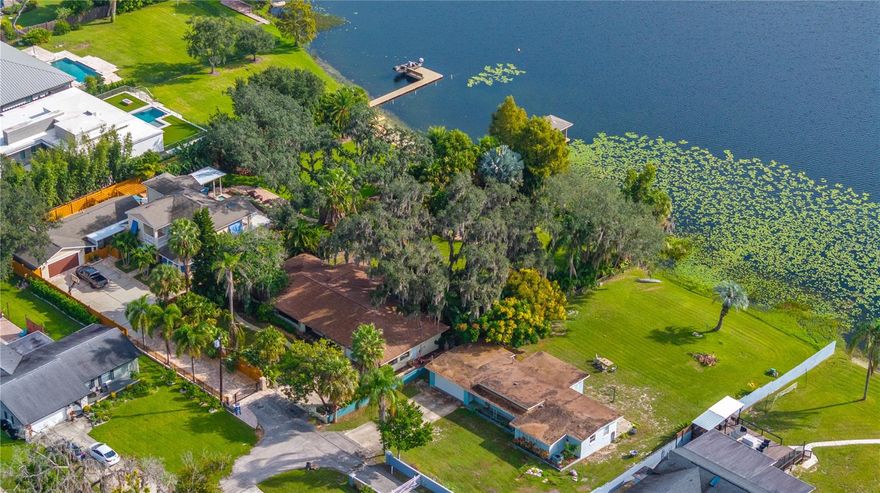 Perfectly positioned on the tranquil shores of Lake Seminary, this beautiful home offers the ultimate lakefront lifestyle in the heart of Maitland. From the moment you arrive, the home’s refreshed landscaping and elegant façade set the tone for what awaits inside. Step through the doors and you’re greeted by open living spaces accented by engineered hardwood floors, stylish finishes, and large windows that frame breathtaking views of the lake. The kitchen is a showcase of both function and design, featuring stainless steel appliances, generous counter space, and an open layout perfect for both entertaining and everyday living. The living room takes full advantage of the home’s lakefront setting, offering panoramic water views. The primary suite serves as a private retreat, featuring a large bathroom with dual vanities, a walk-in shower, and a spacious closet. Outdoors, the expansive backyard offers endless possibilities, whether you envision a custom pool, extended patio, or simply space to unwind and entertain with stunning lake views. An above-ground hot tub and patio overlook the glistening lake, creating the perfect setting to unwind while enjoying kayaking, boating, and fishing right from your own backyard. Set on nearly an acre of pristine land, the property features  a rare combination of privacy, space, and stunning water views all just minutes from Maitland’s vibrant dining scene and major roadways, this home offers the perfect blend of lakeside tranquility and everyday convenience.