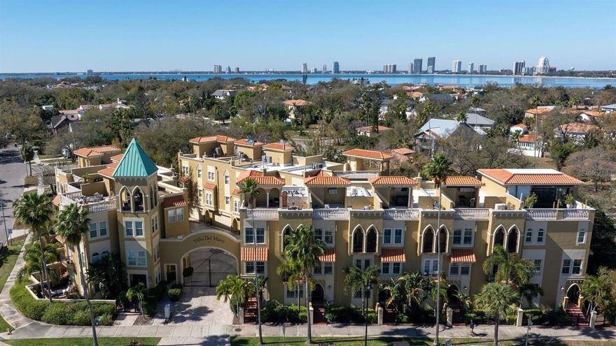 Carefree living on Davis Islands—where neighborhood charm meets city access. Tucked just minutes from downtown Tampa, this gated Mediterranean townhome offers more than 2,800 square feet across three levels and rooftop terrace, all connected by a private elevator and anchored by solid concrete construction (even between floors).Light through oversized windows and high ceilings add to the open feel. With four bedrooms and three-and-a-half baths, the layout is as flexible as it is spacious. The ground-floor suite—complete with full bath and generous storage—works beautifully as a guest retreat, second primary suite, or a private home office. Upstairs, the main living level is designed for gathering. A large, open kitchen features double ovens, abundant granite counter space, and solid wood cabinetry. It flows easily into a cozy breakfast nook and an expansive dining and living area, with French doors that open to a balcony for fresh air breezes. The third floor is home to the primary suite, complete with its own covered balcony. A walk-in closet and spacious bath with dual sinks, soaking tub, and separate shower create a comfortable retreat. The laundry closet is conveniently located between the bedrooms for everyday ease. At the top, your private rooftop terrace delivers sweeping downtown views—the perfect backdrop for evening cocktails. Practicality matches beauty here. Elevated construction adds peace of mind. This home did not flood—not even the garage—and a whole-house generator keeps everything running, even during a storm. From your front door, it’s an easy walk or golf cart ride to the village shops, restaurants, marina, tennis courts, dog parks, waterfront green space, and the historic pool. You’re also moments from Tampa General Hospital, Tampa Riverwalk, Amalie Arena, Hyde Park Village, Bayshore Boulevard, and Tampa International Airport. Zoned for highly regarded schools, including Plant High School. A rare opportunity to enjoy island living with city convenience—without compromise.