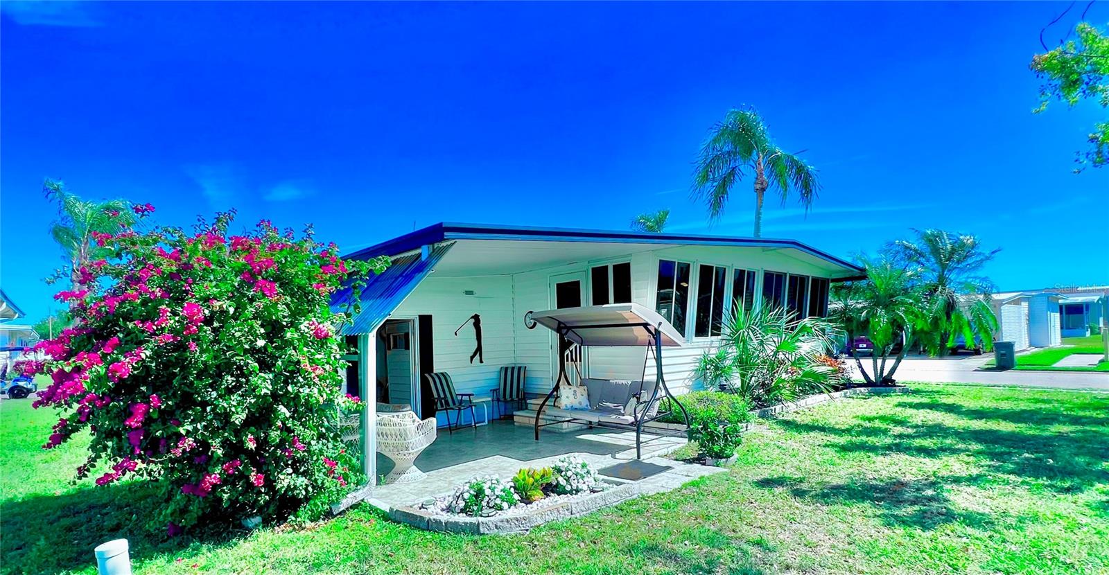 EXCEPTIONAL LOCATION WITH BREATHTAKING SUNSET VIEWS!!! ONE OF A KIND CORNER LOT GOLF COURSE LOCATION!!! Pride of ownership shines throughout this beautifully maintained, fully furnished 2-bedroom, 2-bath home, ideally situated on a desirable corner lot with a back patio overlooking the #9 Green ON THE GOLF COURSE with a view!!!! Just a short walk to the clubhouse and all community amenities, this home offers both comfort and convenience in a resort-style setting. Inside, you’ll find an updated kitchen with modern ceiling lighting, bamboo flooring, crown molding, baseboards, ceiling fans, and plantation shutters in almost every room. Both bathrooms have been completely renovated from top to bottom, and the home features fresh interior paint, new interior and exterior doors, and a dedicated office desk area—perfect for working from home. Additional upgrades include newer windows throughout, a roof-over with vinyl siding, and a newly sealed driveway with clear coat. The exterior shed houses a workshop along with a newer washer and dryer, and a newer water heater has been installed for added efficiency. New TVs are included, making this home truly move-in ready. Whether you're looking for a seasonal retreat or a year-round residence, this exceptional property offers it all. Fairway Village is more than a neighborhood—it’s a lifestyle. Residents enjoy a stunning new 19,000 sq. ft. clubhouse that hosts dances, bingo nights, and endless social events. Take a dip in one of two heated pools, soak in the jacuzzi, challenge your neighbors on the shuffleboard courts, or play a round on the 9-hole par-3 golf course for just a small fee. With low monthly maintenance fees of just $401 (including water/sewer, garbage, lawn care, cable, and internet), this vibrant 55+ community offers not just affordability, but an incredible quality of life. You’re also minutes from Florida’s best beaches, international airports, and countless attractions that make every day feel like a vacation. This home isn’t just four walls—it’s the next beautiful chapter of your story. A place to slow down, stretch out, and feel truly at peace. Schedule your private tour today and come see why Fairway Village is the place you’ve been waiting to call home.