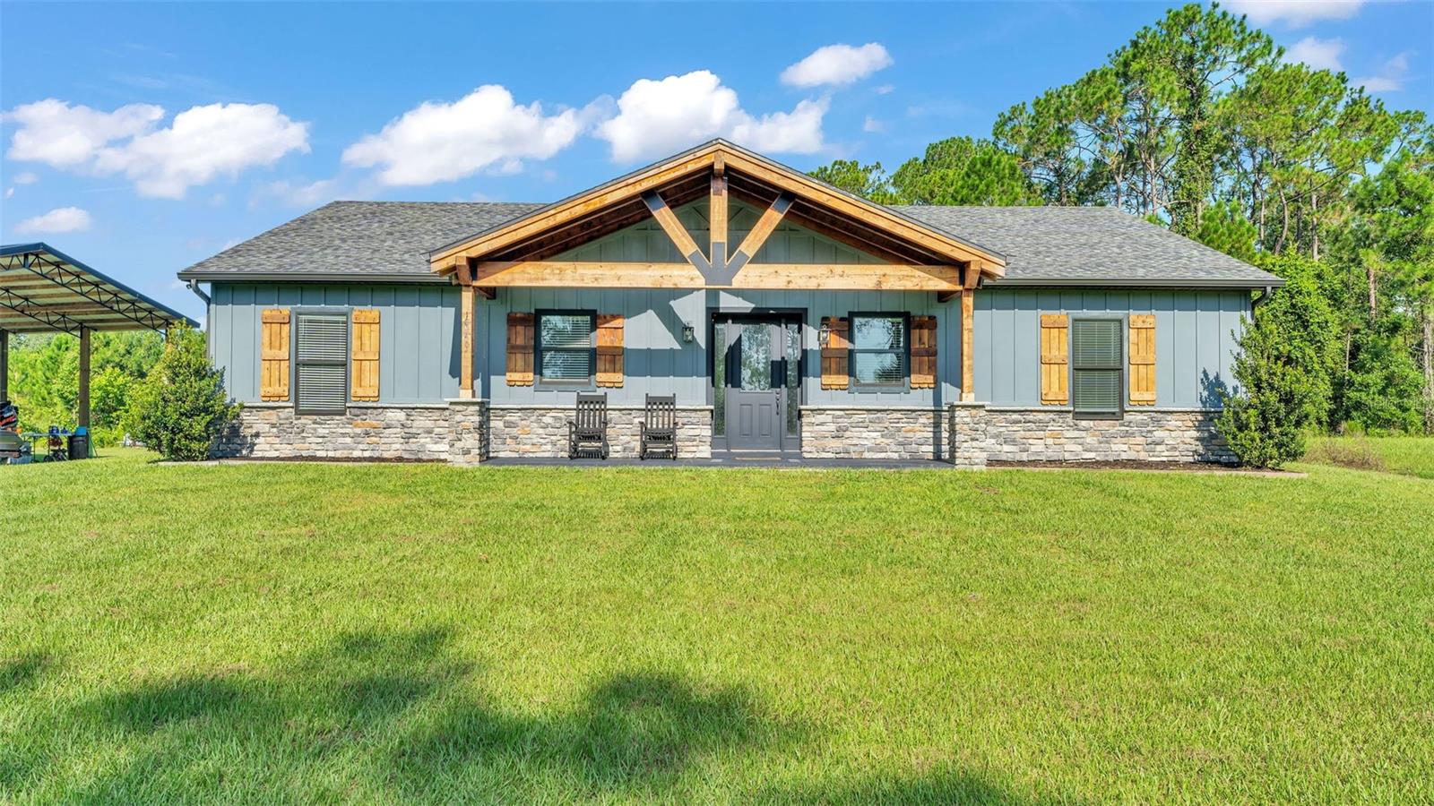Welcome to 18940 Commonwealth Ave located in one of the few places you can still find that "Old Florida" feel. This 3 bed 2 bath home is only 4 years young and sits on approximately 2.65 FENCED acres with a large pole barn. As you pull up to the gate you will see hedges maturing to give you the privacy you desire. The interior of the home is a split floorplan with the Primary bedroom separate from the other 2 bedrooms which a connected by a jack and Jill bathroom. The main living areas are a finished concrete, The kitchen features real wood cabinets, Beautiful granite counters and Stainless appliances. Other Notable features include Crown Moulding, Large Baseboards, a fireplace and Large Screened in back porch, and a deck to enjoy the Florida Sun! Don't wait to schedule your showing.