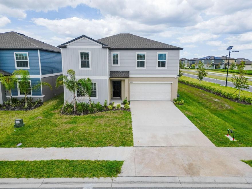 Discover this spacious home located at 12227 Radiant Gem Trl in Parrish, FL. Move-in ready and designed for multi-generational living, this beautifully upgraded 5-bedroom, 3-bath home has over $30,000 in upgrades and features two private suites—one upstairs and one downstairs—along with an expansive loft great for a second living area, media room, or home office; enjoy stunning lake views from the extended lanai, excellent for relaxing or entertaining, all situated on a desirable corner lot for added privacy and curb appeal, with additional highlights including an electric vehicle charger in the garage, open-concept living spaces, and modern finishes throughout, all located in a resort-style community with amenities such as tennis courts, pickleball courts, and a resort-style pool.