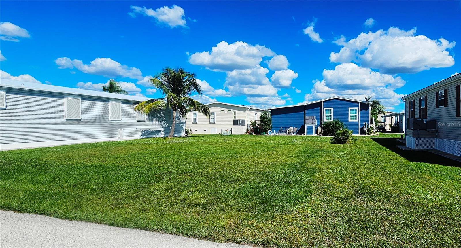 Discover the perfect spot for your custom manufactured home in the highly sought-after 55+ community of Windmill Village!
This vacant lot is already cleared and leveled—ready for you to bring your vision to life. Enjoy a carefree lifestyle with a low monthly HOA fees, which covers water, sewer, trash, and common area upkeep. Windmill Village offers a vibrant, active atmosphere with outstanding amenities, including two private marinas, a boat ramp, shuffleboard, bocce ball, billiards, pickleball, and a spacious community center with a variety of hobby clubs. Relax or host gatherings at The Pavilion beside the heated pool, the perfect place to socialize and unwind.