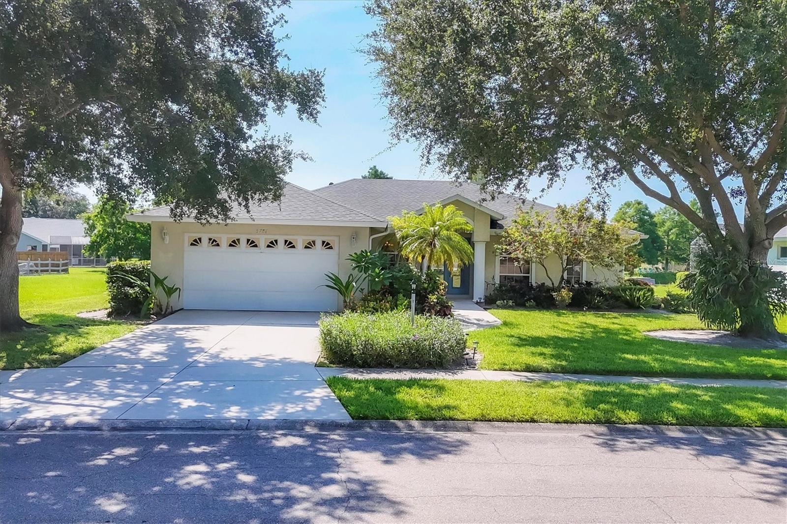 Welcome to 5786 Sandy Pointe Drive, a beautifully maintained lakefront pool home in Grove Pointe—one of Sarasota’s most established and centrally located neighborhoods. From the moment you step inside, your eye is drawn to the tranquil water views of the pool and where the shimmering lake becomes a daily backdrop for relaxation and outdoor living. With 4 bedrooms, 3 full baths, and a den, this single-level residence offers a flexible layout that suits everyday living and easy entertaining. Step inside and you’re welcomed by a comfortable living area with tray ceilings, crown molding, recessed lighting, and a wood-burning fireplace. Sliding glass doors open to the lanai, filling the space with natural light and providing a beautiful view. The adjoining dining room features an arched front window, classic chandelier, and decorative trim, perfect for family dinners or gatherings. The kitchen is functional and charming, with white raised-panel cabinetry, granite countertops and backsplash, stainless steel appliances, and a breakfast bar with pendant lighting. Just off the kitchen, a built-in breakfast nook adds character. A set of French doors opens to a den that’s ideal for a home office, complete with built-in bookshelves, crown molding, and a large arched window. The split-bedroom floor plan offers privacy, with the primary suite tucked away and featuring French doors to the pool, transom windows, a walk-in closet, and a spacious en-suite bath with soaking tub, glass block shower, dual vanities, and a private water closet. Two spacious, well-appointed guest bedrooms sit on the opposite side of the home with a shared nearby guest bath includes a tub/shower combo and vanity. The third guest suite doubles as a large bonus room with built-in cabinetry, en-suite bath with pool access, and generous closet space, perfect for guests, a media room, or playroom. Outside, the screened lanai invites you to relax and unwind, with lighting, and access from the primary suite, living room, and bonus room. The rectangular pool has been recently resurfaced and upgraded with new tile and a heater (2024), while the backyard offers privacy and a peaceful view of the lake. Additional highlights include a functional laundry room with storage and a two-car garage. The home is equipped with laminate flooring in main areas, spray foam attic insulation, energy-efficient solar panels (2022), a new HVAC system (2025), whole house water filtration system and an asphalt, shingle roof (2018). Set in a quiet, tree-lined neighborhood, Grove Pointe is known for its convenient location. You’re minutes from I-75, top-rated schools, and local parks. Siesta Key’s world-famous beaches, downtown Sarasota, the Legacy Trail, and University Town Center are all just a short drive away. This is a great opportunity to enjoy a spacious, move-in-ready home in one of Sarasota’s most desirable areas offering comfort, value, and potential all in one.