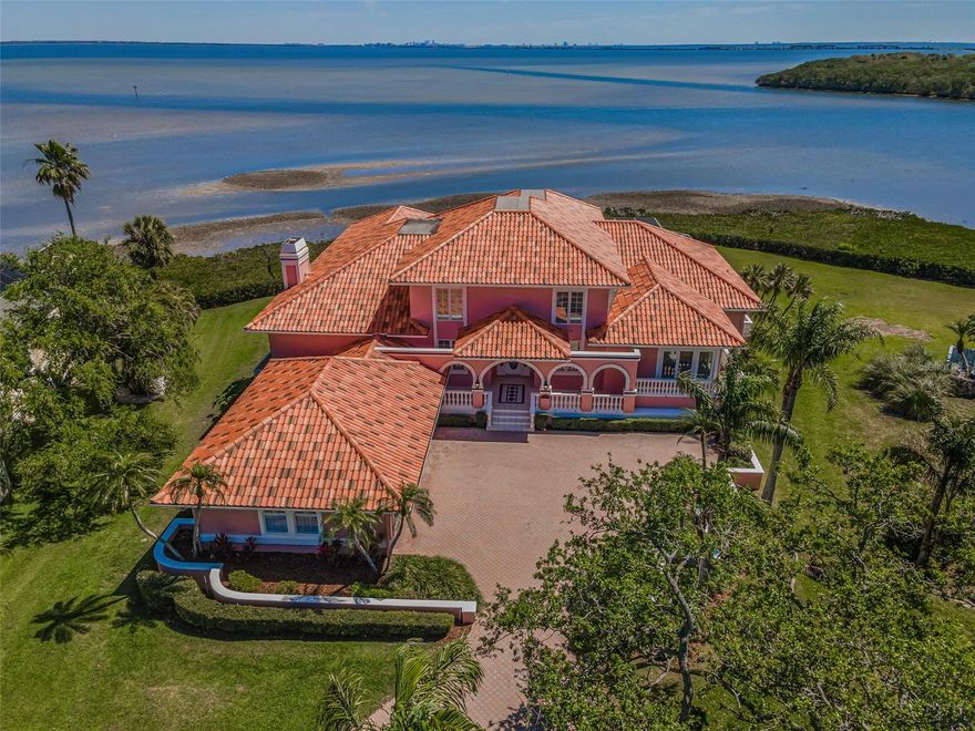 NO WATER INTRUSION TO THE RESIDENCE ...EVER. 
Nestled in a private gated enclave just one mile from charming downtown Safety Harbor, this 5,512 sq ft luxury waterfront estate offers the ultimate Florida lifestyle with breathtaking bay views from every room.

Set on .64 acres, this four-bedroom, 4.5-bathroom home is designed for security, comfort, and elegance. Inside, soaring ceilings, and a gas fireplace. Pella double-paned windows fill the home with natural light, while plantation shutters on windows and sliding glass doors add timeless style. The spacious kitchen flows seamlessly into the living areas, making it perfect for entertaining.

The primary suite is a true retreat, featuring a bonus room overlooking the bay, ideal for a home gym or relaxation space. A second-floor office provides stunning waterfront views, while another bedroom boasts a bonus craft/sewing room for added versatility. Every walk-in closet is customized with built-in closet systems, offering ample storage throughout.

Venture outside to enjoy the screened lanai with an in-ground, pool and spa, where you can unwind while taking in the wildlife, birds, and serene water views. This home also features a whole-house generator, a Life Source water system, three air conditioners, and a new water heater. An elevator provides effortless access between floors. 

Completing this stunning property is a spacious three-car garage and a basement space under the home providing storage or use your imagination to create an enormous, unique play space. Braeside Place is a Prime Location offering easy access to Tampa, Clearwater, St. Petersburg, and beyond. This rare waterfront estate is a must-see for those seeking luxury, privacy, and unparalleled views.