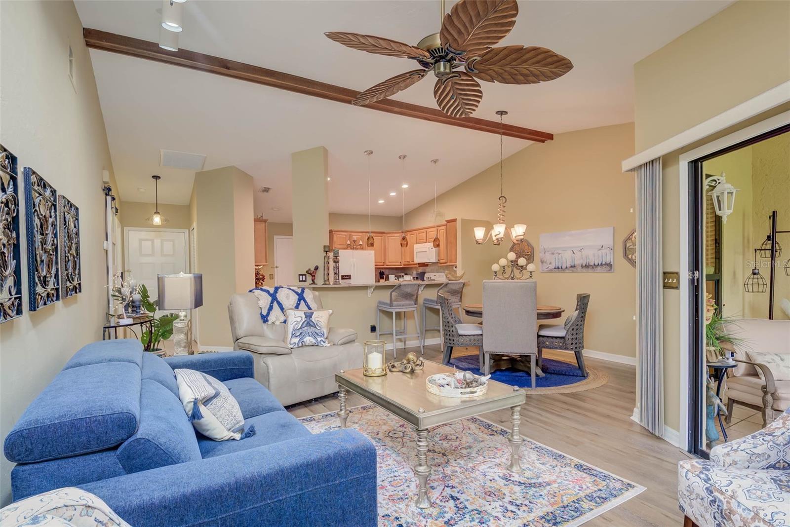 NO FLOOD ZONE – STEPS TO POOL – DUAL ENSUITES! Updated 2BR/2BA villa in gated Governors Island, just steps from the community pool. Rare layout with two ensuite bedrooms, ideal for guests or multigenerational living. Vaulted ceilings with exposed beams, granite kitchen with wood cabinetry, and LVT/tile throughout. Enclosed, air-conditioned lanai adds flex space for office or den. Enjoy a gated front courtyard plus a private backyard patio for grilling and outdoor dining. Prime location behind Bell Tower Shops—minutes to shopping, dining, airport, beaches, and spring training. Low HOA covers exterior insurance, roof, cable, Wi-Fi, lawn care, pest control, and more.