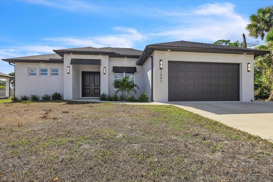 Welcome to this exceptional 2023 custom-built residence, offering over 2,640 square feet of thoughtfully designed living space. This open-concept home features 3 bedrooms plus a den/office, 2 bathrooms, and a 2-car garage. At the heart of the home, the chef’s kitchen is a showstopper, crisp white shaker-style cabinetry with brushed gold hardware, quartz countertops. An oversized island provides ample prep space, casual seating, stainless-steel dishwasher, all highlighted by elegant pendant lighting. Professional-grade stainless steel appliances, recessed lighting, and soaring ceilings complete this bright, airy, and highly functional space. The dining area flows seamlessly from the kitchen, making everyday meals and entertaining effortless. The living room has an electric fireplace that changes color for every mood. Additional upgrades include impact-rated windows and doors, soft-close cabinetry, contemporary light fixtures, and recessed lighting in the living room, dining area, primary suite, office, and secondary bedrooms. High ceilings throughout create an open, inviting atmosphere, with a striking tray ceiling in the primary suite. The spacious primary bedroom features walk-in closets, a double vanity, and a beautifully appointed walk-in shower. On the opposite side of the home, two large guest bedrooms share a full bathroom. The laundry room is thoughtfully designed with an extended countertop, built-in sink, storage, and space for a washer and dryer. Sliding glass doors—including a three-panel slider in the living room and a double-panel slider in the primary bedroom—open to an expansive 27+ foot covered porch/lanai, ideal for relaxing or entertaining. Perfectly situated in the growing City of North Port, with easy access to Port Charlotte, this home is just minutes from Warm Mineral Springs, the North Port Aquatic Center, schools, shopping, dining, and a short drive to Florida’s stunning beaches. **PLEASE ENJOY THE 3D INTERACTIVE VIRTUAL TOUR ASSOCIATED WITH THIS LISTING**