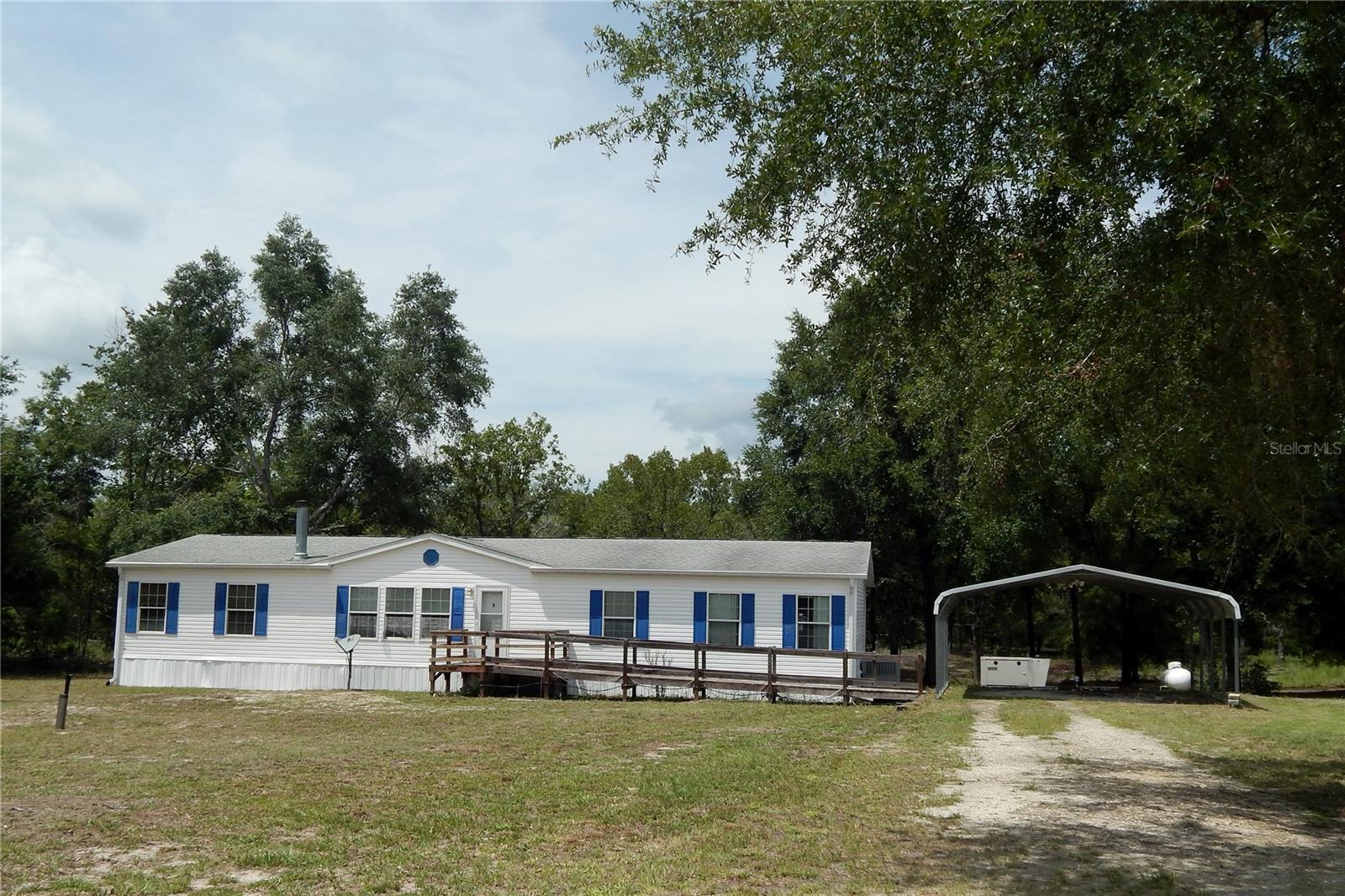 Check Out this Great 2009 3Bdrm/3Bath DWMH w/ Den/Office or 4th BDRM on 6.3 Wooded Acres w/Some Pasture! Home Features 2 Master Suites w/Walk-In Closets, Vinyl Plank/Tile/Engineered Hardwood Flooring, Tape & Textured Walls, Crown Molding and 6" Baseboards Thru-Out, Huge Kitchen w/Gas Stove and Lg. Open Dining Room! Wood Burning Fireplace in Living Room and this House is Handicap Accessible w/ Front Ramp, 36" Doorways and has a Whole House Generator! Exterior Features 30 Yr Architectural Shingle Roof, 2 Metal Shops w/One Rollup Door, Leaf Filter Gutters w/French Drains on all sides of the Home, and a Great 14x20 Covered Back Deck Overlooking the Woods and a Small Fenced in Area for your Animals! No HOA or Deed Restrictions! Close to Rivers and Springs and Low Gilchrist Co. Taxes!