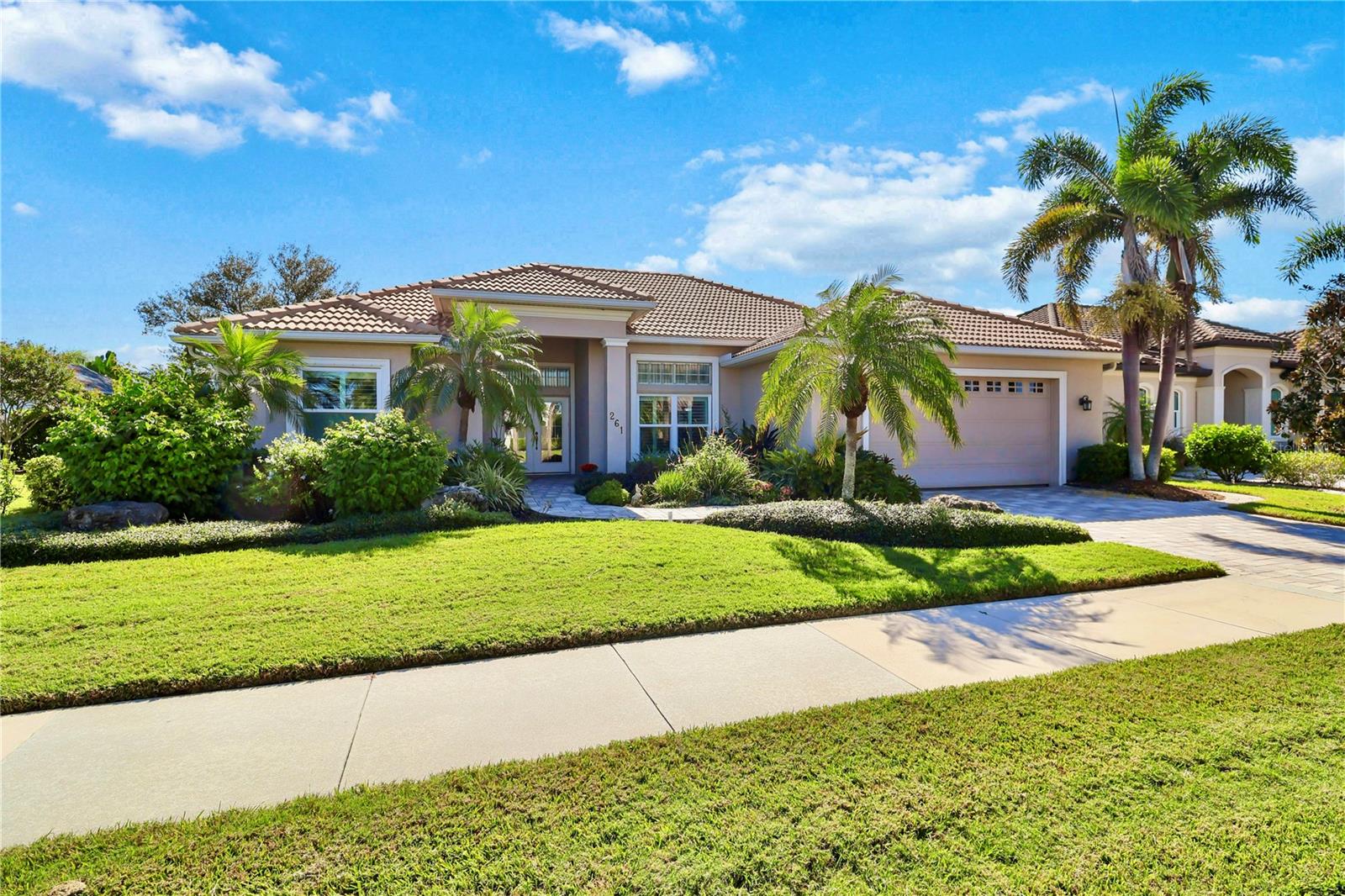 Impeccable curb appeal and refined Florida living await you at 261 Venice Palms Boulevard. Located in the community of Venice Palms, just minutes from “Venice Island”, this residence captures timeless style and meticulous care. Framed by lush tropical landscaping, a paver driveway and walkway, and a durable barrel tile roof, the home makes a stunning first impression!
Beautifully appointed with 3 bedrooms, 2 baths, and just over 2,100 square feet of refined living space, the open, light-filled layout features volume ceilings detailed with crown molding, tile flooring laid on the diagonal in the main living areas, and rich hardwood floors in all bedrooms.
A large chef’s kitchen showcases natural wood cabinetry, granite countertops, stainless steel appliances, and a generous breakfast bar that seamlessly connects to the main living area—perfect for entertaining. The great room is anchored by a custom-built TV console with display shelving, creating both a beautiful focal point and functional storage. The primary suite offers a peaceful retreat with large glass sliding doors opening to the pool, a built-in wall dresser, dual closets, and a spacious ensuite bath.
Enjoy the tranquil setting of the screened lanai, where a saltwater pool with a new heat pump invites year-round enjoyment and comfort. The pool cage has been recently rescreened, and the lanai is fully equipped with accordion-style hurricane shutters for protection and peace of mind. Recent upgrades to this home include impact-rated front windows (2025), a new A/C system (2023), and a Culligan whole-house water softening system with reverse osmosis at the kitchen sink. Additional features include a central vacuum system, custom lighting, tinted windows, hurricane protection throughout, and a recently updated water heater.
Located within a beautifully maintained community with no CDD fees and modest HOA dues that cover lawn service, fertilizer, pest control and irrigation. Community has a paved .67 mile bike/walking path and a community-owned filtered well system for irrigation. This home allows you to enjoy a truly relaxed lifestyle. 261 Venice Palms combines timeless appeal with quality upgrades and a serene natural backdrop, exemplifying luxury, comfort and attention to detail.