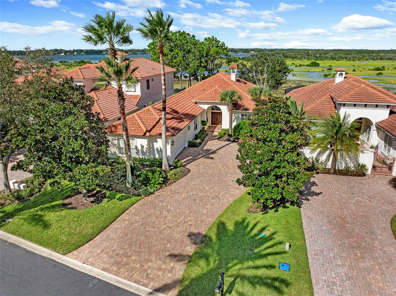 Located in the exclusive Marsh Creek Country Club on Anastasia Island, this custom home offers the perfect blend of elegance, comfort, and lifestyle. With 4 bedrooms, 3.5 bathrooms, and over 3,200 sq. ft. of living space, it is designed for both everyday living and entertaining.
The home’s layout includes a spacious living and dining area, a well-appointed kitchen, and a private office with built-in cabinetry that can easily serve as a bedroom or flex space if desired. The highlight of the property is the enclosed back room featuring walls of windows that capture panoramic views of the intracoastal waterway and the surrounding marsh. This is the ideal space to relax with morning coffee or enjoy evening sunsets while surrounded by natural beauty.
The primary suite is a private retreat with ample closet space and a spa-inspired bath. Secondary bedrooms are generously sized and include en suite access, providing comfort for family or guests. A two-car side-entry garage, tile roof, and thoughtful finishes throughout add to the appeal.
Living in Marsh Creek means more than a beautiful home—it’s a lifestyle. This gated community is the only golf course on Anastasia Island, offering optional memberships, tennis, dining, and 24/7 security. You’ll be just minutes from the beach, historic downtown St. Augustine, and top-rated St. Johns County schools.
This home combines luxury and location in one of St. Augustine’s most desirable neighborhoods.