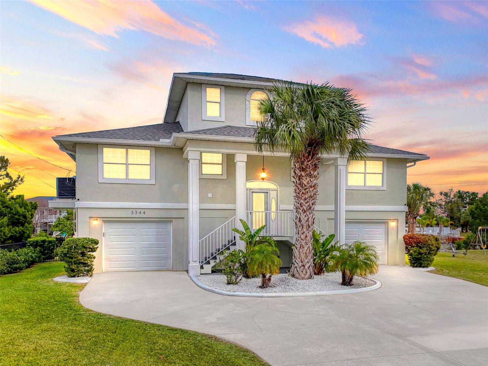 HUGE PRICE REDUCTION!!! Love where you live in the highly sought-after waterfront community of Hernando Beach, Florida! This beautifully maintained 4-bedroom, 2.5-bathroom home offers three stories of functional space, including two levels of living and a dock. Step inside to feel the warmth and care poured into this home. Recent upgrades ensure move-in-ready convenience, including a new A/C unit with a 10-year transferable warranty (covering parts, labor, and maintenance), a new hot water heater, a new electrical panel, new gutters with underground drainage, and a newer roof (2021). The kitchen shines with new quartz countertops, new stainless steel appliances, farmers sink, lots of beautiful cabinets and under-cabinet lighting, while the bathrooms boast new fixtures and marble countertops. The main living area is elevated just a few steps up, leading to a spacious family room with a wood-burning fireplace and two oversized PGT non-impact pocket sliding glass doors that open to an expansive lanai spanning almost the width of the home. The open-concept design flows seamlessly into the oversized dining area and walk-in pantry. Three generously sized bedrooms, a convenient laundry room with additional storage complete the main level. Upstairs, the private master retreat features large windows for abundant natural light, a huge walk-in closet, and an en-suite bath with double sinks, marble countertop,a Jacuzzi Garden tub, and a stylish tiled walk-in shower. The private master lanai is the perfect place to unwind. On the ground level, two oversized garage spaces with storage rooms, along with a half bath for convenience. A custom wood bar area opens to a screened-in lanai—ideal for entertaining. The backyard leads to a spacious dock, ready for your boat and waterfront adventures. which has perfect space for your boat and if you don't have a boat it's a great excuse to get one. No expense has been spared in making this home an exceptional waterfront retreat. Don't miss out—schedule your private showing today! Additional .17 acre lot next door (key #169178)available. A Lender credit is being offered, ask for details.