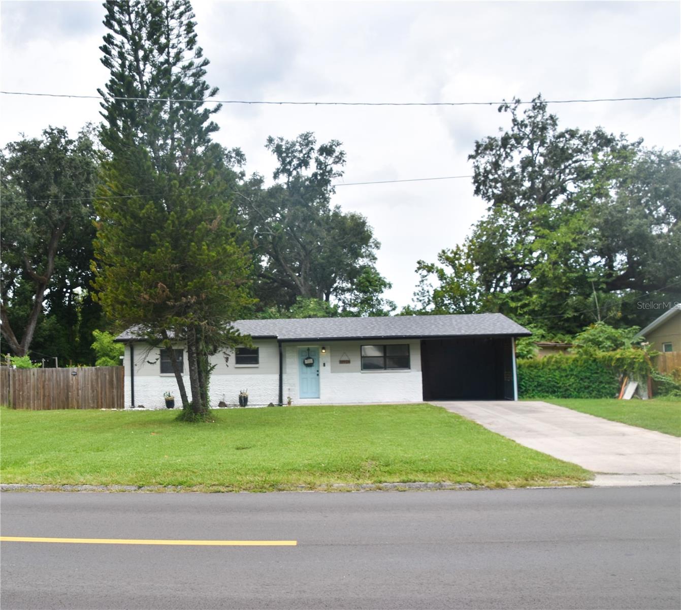 This beautifully remodeled home sits on an oversized lot with two work shed/artist spaces, and has plenty of room for an ADU AND a POOL! Brand new roof - 2025! Brand new A/C - 2025! Newly renovated kitchen with granite countertops, soft-close cabinets, farmhouse-style sink, and stainless steel appliances! Tile floors throughout the entire home. Even the carport is updated with brand new solid wood. The Florida room with 4 foot windows boasts panoramic views to the spacious yard. The house sits on the highest point in Tampa, out of flood zones. It's a turn key starter home with potential for even more! Close to Babe Zaharias Golf Course, I-275, and downtown Tampa. Schedule a tour for this must see home today!