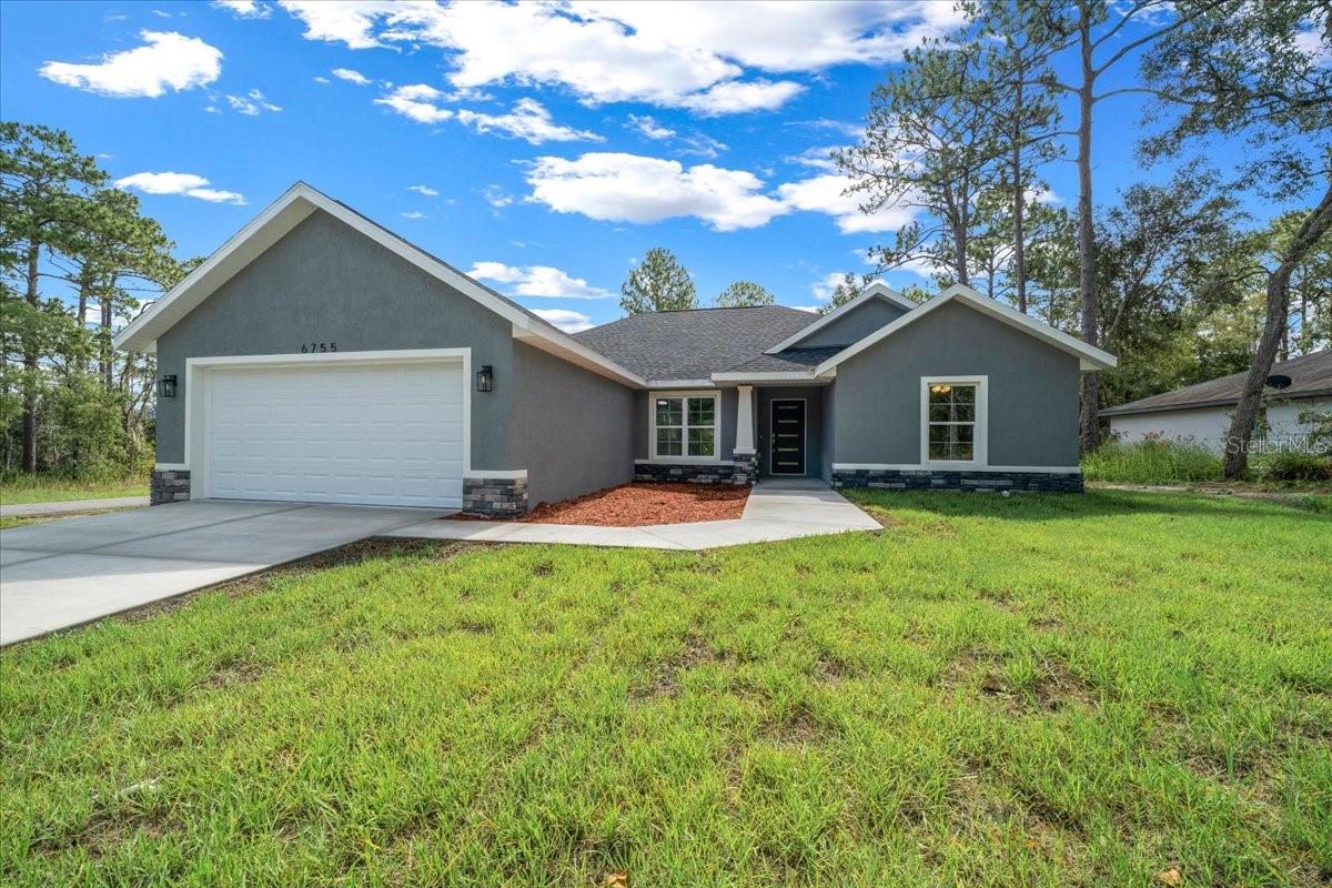 COMPLETED AND MOVE-IN READY! SELLER WILL PAY SOME OF THE BUYERS CLOSING COST when using preferred lender. Be the first to own this beautiful brand-new home in the desirable community of Citrus Springs—with no HOA and on a CORNER LOT! Designed with modern living in mind, this home features a spacious open floor plan and a split-bedroom layout for added privacy. Inside, you’ll find three bedrooms and two bathrooms, including a generously sized master suite with a walk-in closet and a luxurious en suite bathroom complete with a relaxing soaking tub and separate shower. The open-concept kitchen and living area are perfect for entertaining, and feature stylish quartz countertops. Enjoy the convenience of an indoor laundry room and step outside to a large covered back porch—ideal for relaxing or hosting family and friends. Don’t miss your chance to own a brand-new home with quality finishes in a peaceful setting. Schedule your tour today!