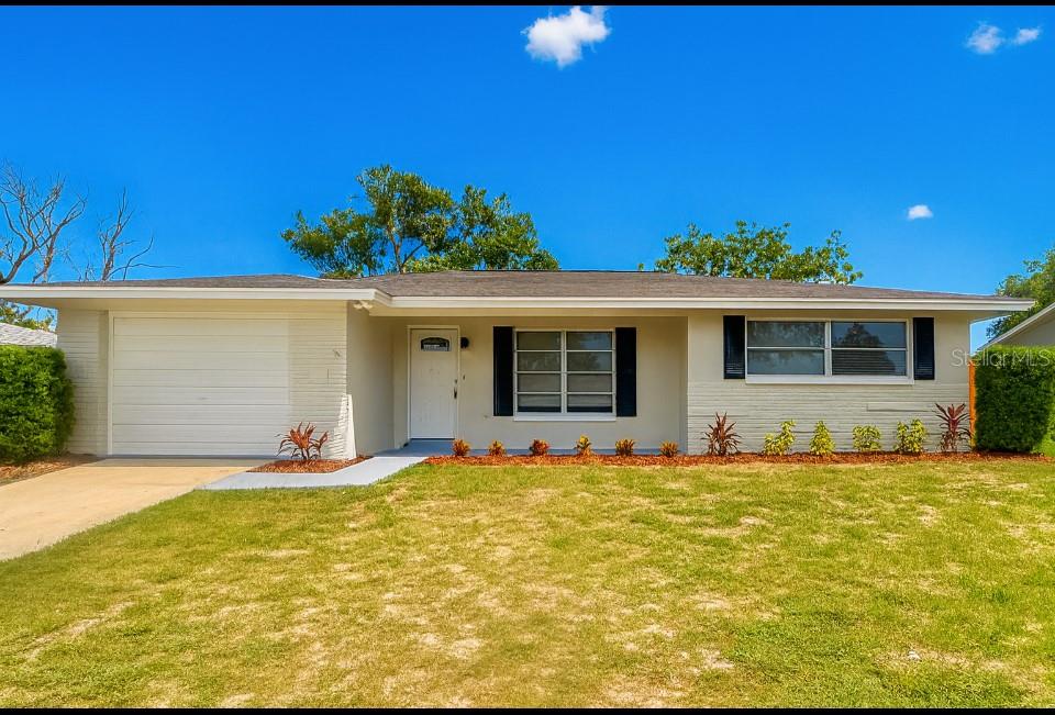One or more photo(s) has been virtually staged. If you are looking for a truly turn-key home, your search is over! Enjoy easy living in this newly remodeled home that offers NEWer roof, NEW AC, NEW water heater, NEW kitchen, NEW interior & exterior paint, and NEW LPV flooring throughout. As you enter the front door, your eye goes right to the spacious living room and the dinette area which overlooks the modern kitchen. Kitchen is ALL NEW with modern soft close cabinets, beautiful granite counters, farm style sink, and upgraded stainless steel appliances. The primary bedroom includes an updated bathroom with a walk-in shower. The second bedroom offers ample space and is located near a renovated guest bathroom with a tub/shower combination. Additional new upgrades include new AC ductwork with insulation and upgraded electrical panel. Off the dining room there is access to the enclosed covered porch overlooking the backyard which is completely fenced. This home is situated within the Jasmine Lakes community, conveniently close to restaurants, shopping venues, and parks. There are no HOA fees, deed restrictions, or flood insurance requirements, and the home has never experienced flooding. This property is well-suited for first-time buyers, those seeking a vacation home, or investors looking for a move-in ready rental.