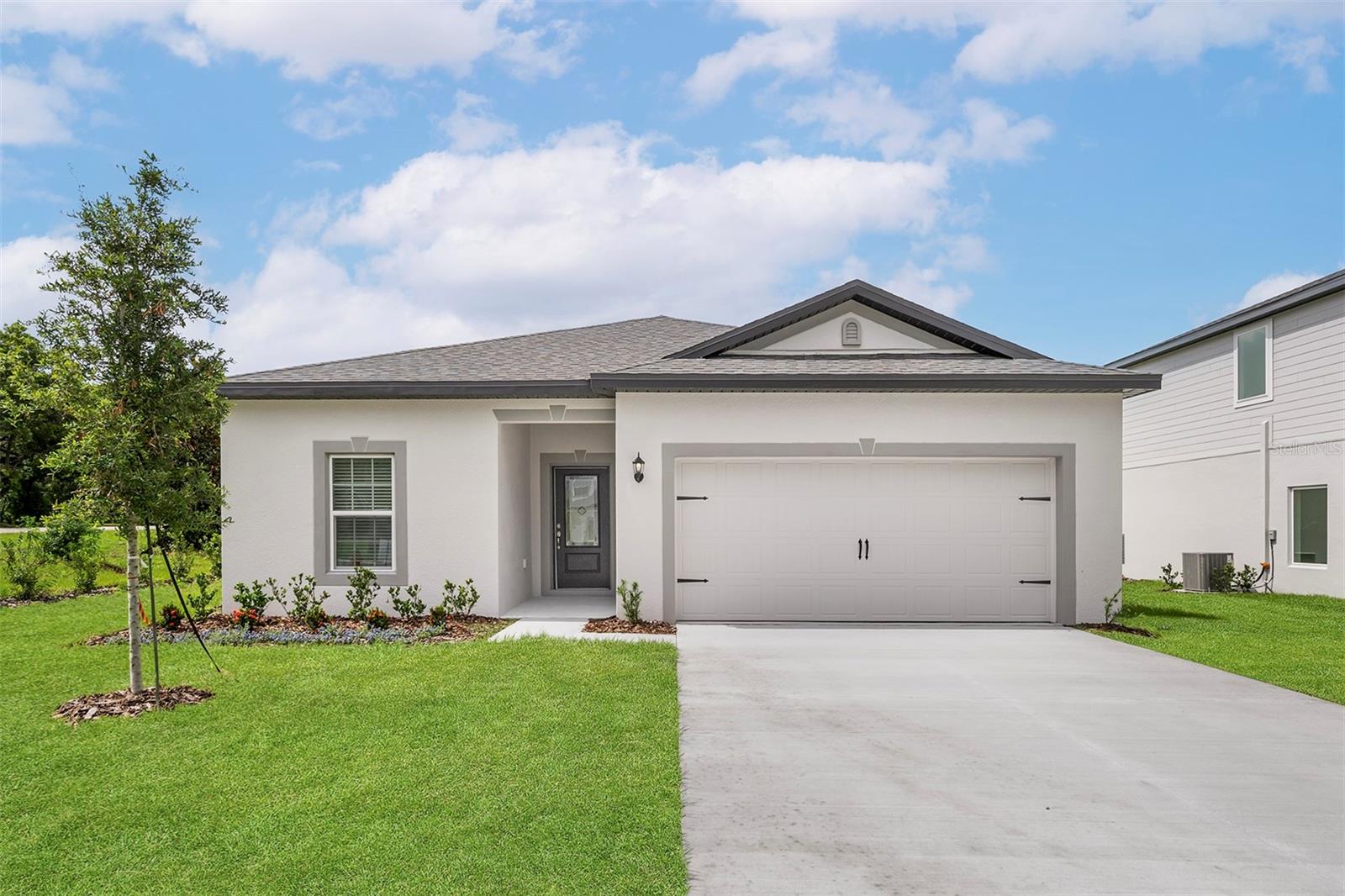 Pre-Construction. To be built. Step into style and comfort with the Amalie model at Tula Parc in Astatula, FL! This thoughtfully designed 3-bedroom, 2-bathroom home delivers the perfect blend of function, flow, and flair—ideal for everyday living and weekend entertaining.
The layout begins with two spacious secondary bedrooms nestled around a shared full bath—perfect for kids, guests, or even a home office setup. A private laundry room connects directly to the generously sized two-car garage, offering practical convenience right where you need it.
At the heart of the home, the open-concept living area welcomes you in with a bright and airy family room, perfect for cozy nights or casual gatherings. The kitchen is a dream—complete with granite countertops, designer cabinets, modern Whirlpool® appliances, and plenty of room to cook, dine, and connect.
Tucked away at the back of the home, the secluded master suite is a true retreat featuring a large window for natural light, a walk-in closet for all your wardrobe needs, and a well-appointed bathroom with a spacious vanity and built-in shelving for added organization.
With beautiful curb appeal and access to Tula Parc’s community playground and gazebo, this home offers even more beyond the front door. Enjoy life just minutes from Little Lake Harris, where you can spend weekends fishing, boating, or exploring the nearby parks. Plus, you’re only a short drive from the excitement of Orlando’s shopping, dining, and theme parks.
Make your move to the Amalie model—a home that checks every box and then some! Schedule your showing today.