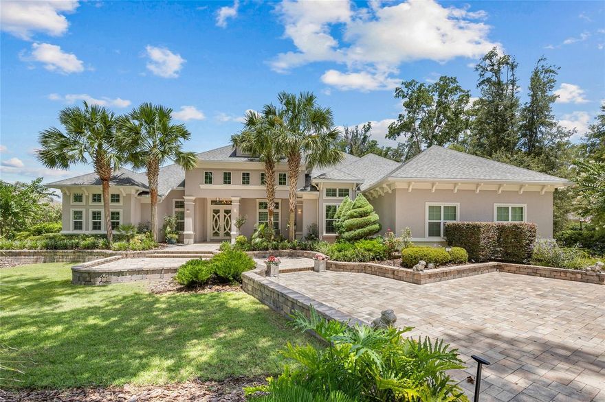 Experience timeless elegance and modern sophistication in this exquisite French Contemporary home by Jeffrey M. Wilde Builders, Inc. where each room holds intricate interior design details directed by the home owners.
Nestled on a lushly landscaped private 1-acre lot in SW Gainesville’s highly desired Oakmont community, a circular driveway and expansive hardscape enhances the grand curb appeal and welcomes you to this 6-bedroom, 4.5-bath masterpiece, where every detail reflects refined craftsmanship, luxury, and comfort. This home’s tranquil setting features a serene pond, large community green space and natural wooded barrier at the rear of the home providing peaceful views and enhanced privacy. 
Designed with intentionality and refinement, the home features hand-scraped French oak wood floors, detailed trimwork and crown molding throughout, and abundant natural light from a desirable southern exposure. The gourmet kitchen is a chef’s dream, complete with a 42” built-in French-door Sub-Zero refrigerator, a 48” dual-fuel Wolf range with double ovens, French cooktop, and warming shelf, accompanied by bright cabinetry, custom marble backsplash, extra-thick quartz countertops and a dramatic mitered-edge marble island. The coffee bar has ample storage and a second Miele dishwasher, and a sunlit breakfast nook overlooking the backyard oasis provide a Florida resort feel. 
Entertain in style with a 500+ bottle wine cellar with a dedicated cooling system, a formal dining room featuring a chandelier imported from Paris, and expansive living areas perfect for both large gatherings and intimate moments. The luxurious primary suite on the main level offers style with a grasscloth wallpaper accent wall and encased, motorized blackout shades. The spa-inspired bathroom has oversized 18” marble flooring and walls, a “warming wall” leading to an expansive custom shower with rain shower heads and body sprayers, and a stunning soaking tub filled with natural light. Dual walk-in closets with custom built-ins, a linen closet and large dual vanity complete the primary bathroom. 
Additional first-floor highlights include three spacious guest bedrooms and two dual sink bathrooms, an eloquent powder room, a fully trimmed office with built-in shelving and cabinetry, and a large laundry room with a dedicated pet bath/boot shower. 
Upstairs, discover two additional bedrooms, including one ideal for an in-law suite with nearby kitchenette and an expansive media room with multi-screen wall—perfect for game days or Netflix movie nights! 
Outdoor living shines with a screened-in retreat featuring an oversized pool and spa with travertine decking, an outdoor fireplace, a gourmet summer kitchen with built-in grill, two-tap kegerator, seafood boil gas cooker, a zoned AV system for TV and audio throughout the space. 
The three-car garage is thoughtfully designed with a 250 AMP power for EV charging or equipment use, with one bay measuring 24’ deep with 14’ ceilings and a 6” slab—ideal for an auto storage lift. 
Located in Oakmont, Gainesville’s premier master-planned community spanning 550+ acres. Enjoy access to a Residents Club with resort-style pool and splash pad, a state-of-the-art fitness center, tennis and basketball courts. All just minutes from the University of Florida, Shands, NFRMC, top-rated schools, and Gainesville’s best shopping and dining.
This rare Oakmont gem won’t last long—schedule your private showing today and experience it for yourself.