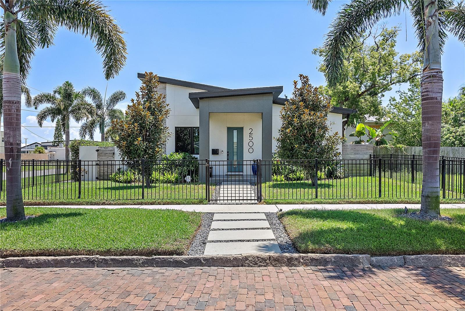 Welcome to your private, newly built designer-curated home in the heart of downtown St. Petersburg! This solid block construction, 4-bed, 3-bath, 2-car garage Pool home is a true hurricane fortress, featuring impact windows & doors and a whole-house Generac generator. Offered fully furnished, this high-end rental is ideally situated just steps from the lively Grand Central District. Situated on a charming brick-lined street corner lot, this stunning home offers a 3 bed-2 bath main house with a 1 bed-1 bath carriage apartment above the garage, all boasting upscale finishes & walkability to restaurants, breweries, art galleries, & more! The striking curb appeal blends contemporary minimalist architecture with a tropical aesthetic to create a bold & refreshing urban sanctuary. Take the walkway to a dramatic portico among lush tropical foliage, where a statement entry door invites you inside. Clean geometric lines, sleek surfaces, & intuitive use of light create an environment with the versatility of a serene retreat or an exciting hosting space. The formal dining room with a dry bar flows into a bright, open layout featuring a chef’s kitchen with Scandinavian-style cabinetry, shining quartz countertops, & luxury appliances including a 6-Burner Thor gas range, high-end built-in microwave & Dual-Door Beverage Cooler. A large breakfast bar overlooks the expansive living area with clerestory windows, vaulted ceilings & views over the pool. A king-sized primary suite features dual closets & a spa-inspired bath with a double vanity, a contemporary shower room with a frameless glass wall. The 2nd & 3rd bedrooms are thoughtfully designed with roomy closets, built-ins, 10-foot ceilings, & optional connectivity doors. Nearby, the hall bath is fitted with modern finishes. Other highlights include a large laundry room with a full-size front-load washer & dryer & whole house RO water filtration & softener. Luxury does not end here. Outside is your private resort: a pavered courtyard with a modern heated in-ground pool & spa. Relax under the covered lanai or enjoy the FL sunshine on the pool deck. A tall privacy wall makes this space your own & a grassy side lawn & mature landscaping give the best resort vibes. A detached 2-car garage off the courtyard provides additional storage, & an interior staircase leads you up to a spacious apartment, perfect for multi-generational living or home office needs. It offers 10' ceilings, wood-look flooring, a large living room, & a spacious bedroom with en-suite full bath. This home places you in one of St. Pete’s most vibrant neighborhoods, surrounded by award-winning shops and dining. You are mins from the St. Pete Pier, EDGE District, and Grand Central, with quick access to I-275 and Gulf beaches. Set near the edge of the Warehouse Arts District, the home is immersed in creative energy, with colorful murals, working studios, and galleries nearby. Rent $8500 per month. Move in requires $8500 security and 1st mo rent with approved application(s); Application fee is $65 per adult occupant; Rent includes internet, pest control, yard maint, pool maint; Tenant is responsible for water, power, trash, gas; Pets considered (NO cats); Small dogs less than 35lb, 2 pets max; breed restrictions apply; subject to approval; $500 deposit & $50 monthly rent per pet; Available Sept 1st. Property is rented furnished - piano and personal items will be removed, dining room table will be added; inquire for partial furnishing options.