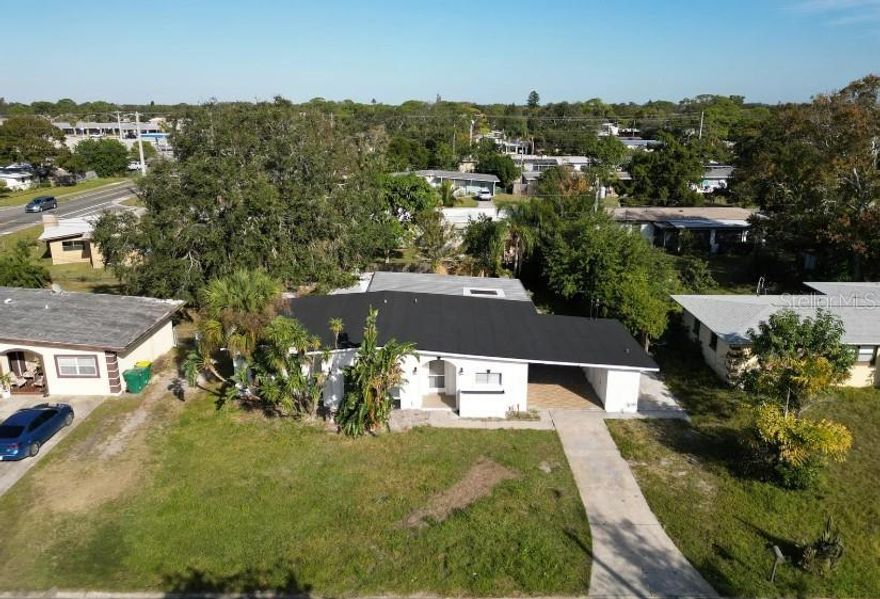 Step into this beautifully updated 3 bedroom, 2 bath home that combines charm, function, and modern upgrades. Featuring a spacious garage and large carport, there’s plenty of room for vehicles, storage, or hobbies. The highlight of the backyard is a cozy pool surrounded by stone, creating the perfect retreat for relaxation or entertaining. Inside, the open floor plan flows seamlessly with wood flooring throughout and tasteful decorative accents adding warmth and character. Recent major updates include a 2024 roof and 2024 A/C system, giving you peace of mind for years to come. This home is truly move-in ready and waiting for its new owner.