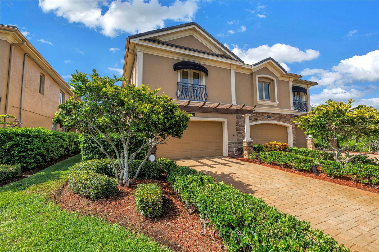 Exceptional Luxury Townhome with Water & Conservation Views – Saxony Place at Carillon is a gated community perfectly located between downtown Tampa and downtown St Pete with two major airports just 15 minutes away! Enjoy the privacy of a end unit townhome with the ease of low maintenance living. This townhome delivers the space of a single family home - formal dining, large kitchen and oversized living space with a wood burning fireplace. The kitchen has a recent renovation, a unique feature for this well built community, that includes solid wood shaker cabinetry, Quartz counters, built-in appliances and a pass-through bar to the living space - ideal for entertaining. Upstairs you will enjoy the privacy of 3 bedroom suites - each room offers en-suite baths and spacious closet storage. The main suite features two walk-in closets, a spa like bathroom with large soaking tub, glass enclosed shower and doubly vanity. A cozy wood burning fireplace sets the mood for a perfect getaway and a bonus sitting room with built-in wet bar complete this retreat. Outdoors, the screen-enclosed lanai overlooks the community water feature and lush conservation area (no rear neighbors!). While the oversized 2-car garage provides exceptional storage. HOA fee $550 covers roof replacement, exterior maintenance, pest control, security guard, grounds maintenance and manager. Luxury finishes, a prime location, and unmatched privacy make this townhome a rare find in Tampa Bay. Exceptionally well built, the home includes double pane, hurricane rated casement style windows and block construction both levels. The community experienced no flooding during the 2024 storm season.