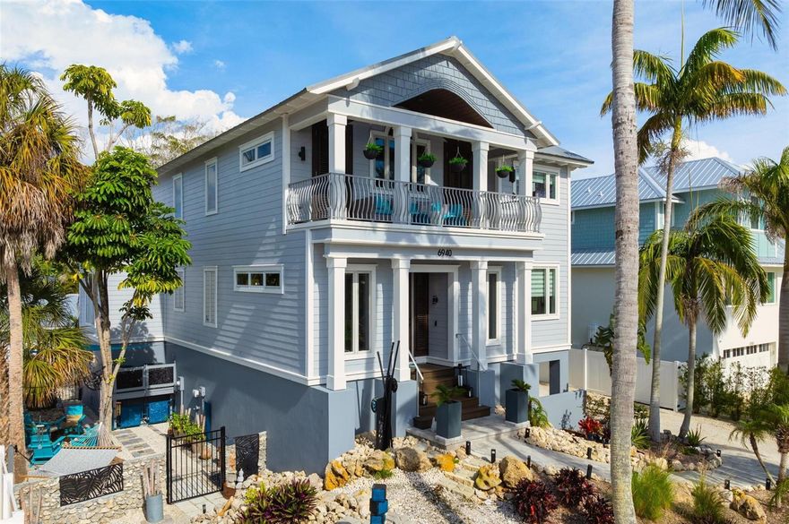 This stunning move-in-ready coastal contemporary Key West style home is located in Longboat Key's coveted historic North-end Longbeach Village area. Originally designed and custom built by Steven Carr for himself, this magnificent open-plan home offers many desirable features and finishes, including stained glass windows, vaulted wood ceilings, built-in shelving, and an elevator. Upgrades include a new metal roof installed in 2024, kitchen with center island and quartzite counters, stainless appliances, art glass fixtures, custom art tile backsplash, LED cabinet lighting, and easy-care luxury vinyl plank flooring throughout the second level installed in 2020. The bathrooms have been redone (2020) with walk-in showers, quartz counters, and high-end finishes. Two new HVAC units (2022), washer/dryer, window treatments (2023), south-side seamless gutters (2020) and technological upgrades, including Google Home thermostats, doorbells, security cameras, wireless Sonos speakers and Wi-Fi extenders to amplify the home's modernized features. The spacious, unique primary suite occupies the entire third level and boasts wood floors, walk-in closets, built-in shelving, and a bonus studio. The large ensuite bath has been upgraded with an oversized walk-in shower, custom ocean life art tile backsplashes and quartz-leathered countertops. The first level oversized garage features two vehicle bays, custom cabinetry, and a large central area accommodating a home gym and/or pool table. There are balconies on every level where you can enjoy comfortable breezes and occasional sounds of the nearby Gulf surf. Exterior areas offer private spaces, including a tranquil Zen garden with fire pit, hammock, and cafe lighting. The lot offers room for guest parking, and a boat that can be launched at the shared neighborhood launch area. Enjoy the uncrowded Gulf beach, fishing piers, and nearby waterfront restaurants, rated among the best in the greater Sarasota area. Words can't describe the unique beauty and charm that this home offers, so please make an appointment to see it for yourself.