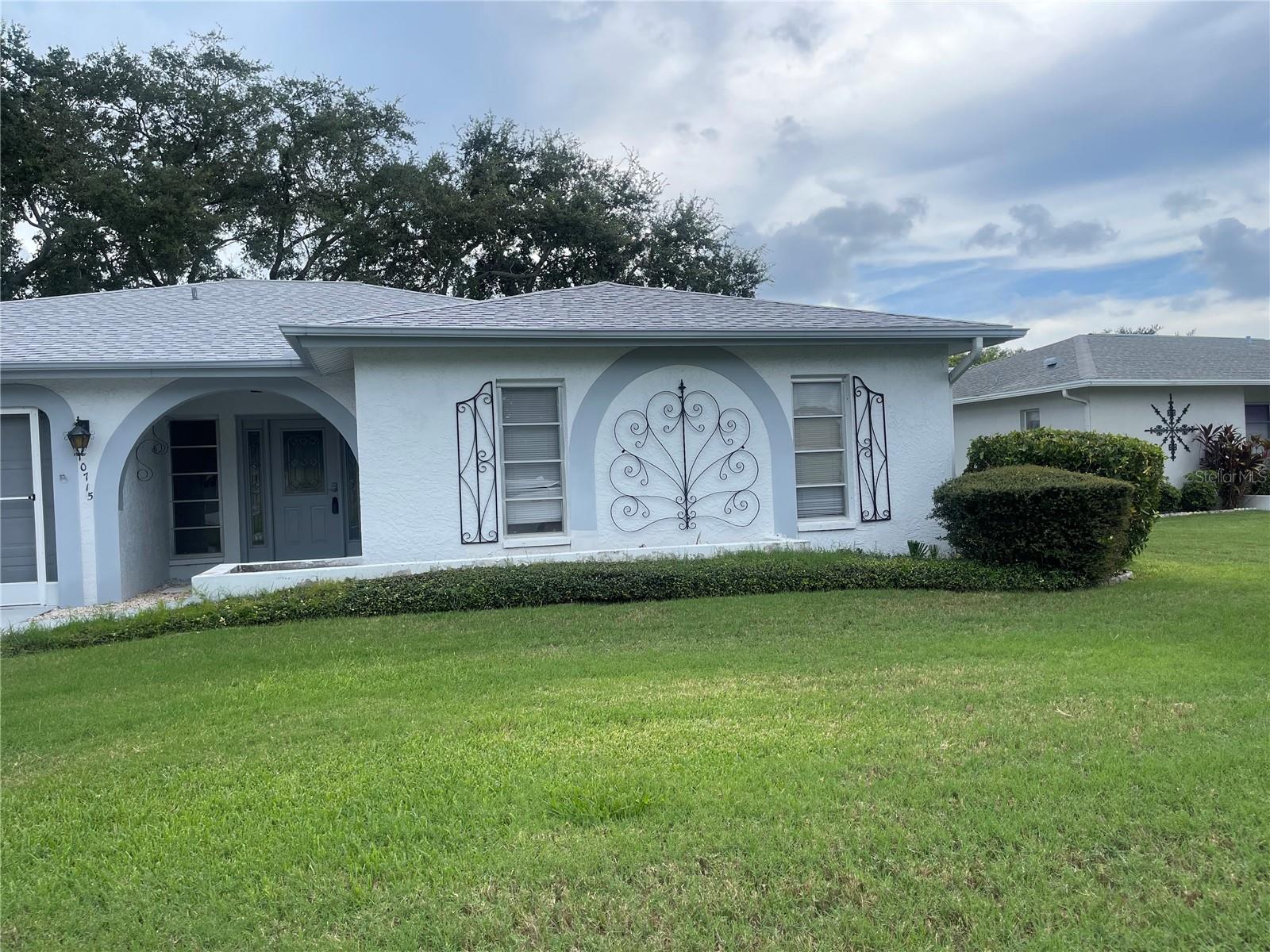 Welcome to this spacious and well-maintained home located on a quiet cul-de-sac, overlooking a serene lake. With no carpet but tile and wood laminate flooring throughout the home. Home is move-in ready and designed for comfort and easy living. Enjoy all the amenities of this active 55+ community, including a clubhouse, sparkling pool, tennis courts and plenty of areas for walking and socializing with neighbors. This golf cart–friendly community truly has something for everyone. The home’s prime location offers unmatched convenience to restaurants, supermarkets, movie theaters, hospitals, and entertainment. A short drive takes you to downtown Port Richey with even more dining and shopping options. Plus, with easy access to the Suncoast/Veterans Expressway (589), commuting is a breeze. Practical updates include a new roof in 2023 and brand-new AC installed 8/16/25 giving you peace of mind for years to come. More pictures coming soon.