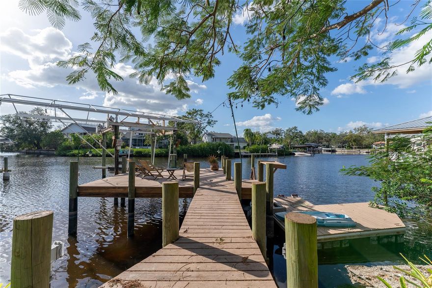 Davis Islands Waterfront property features a prime location on an extra-wide canal leading out to the Bay. (70" of waterfront) Renovate or build your dream home in South Tampa's most sought-after community and enjoy spectacular sunsets year-round. This home boasts an open floor plan and high ceilings. The living room, kitchen, and dining room offer ample space for family time and entertaining. Stunning red brick veined granite counters make a statement. Two bedrooms on the first floor and two bedrooms on the second floor.  The primary suite is oversized with a generous closet. This property has a large Shoreline Marine dock, boat lift, and floating dock. The house is being sold As-Is. The home was professionally mitigated to remediate all areas flooded during Hurricane Helene. You will find the charm of a close-knit community with scenic walks and bike trails.  The downtown village on the island has over a dozen restaurants, shopping, a coffee shop, a post office, a drug store, a bank, a fire department, and Tampa General Hospital. Many DI residents also enjoy Sandra Freeman's clay tennis courts, Peter O. Knight Airport, a sailing and yacht club, two marinas, a sea basin, Historic Roy Jenkins Pool, a small beach, a dog waterpark, a second dog park, a park, baseball field, basketball court, and pickle ball courts.  A+ rated schools. Di is just minutes from Downtown Tampa, Tampa International Airport, MacDill Air Force Base, Bayshore Boulevard, Hyde Park Village, Riverwalk, and Water Street. When you drive over the bridge onto DI you take a deep breathe, relax, and start your island time.
