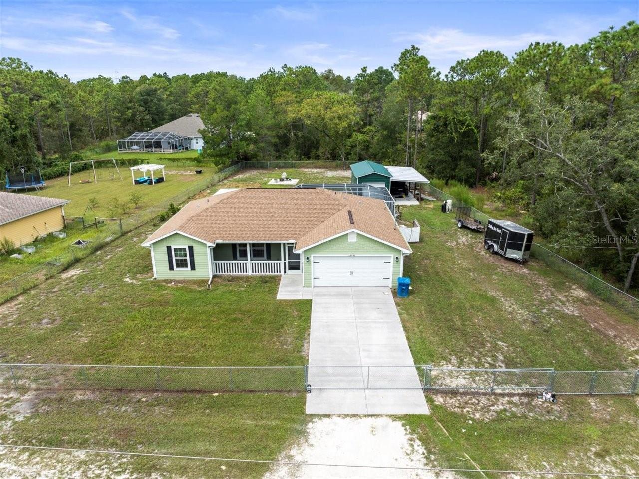 Charming & Clean 2021 POOL HOME on ½ Acre in Royal Highlands - Detached Workshop! Offering "10,000 IN SELLER CONCESSIONS TOWARDS CLOSING COSTS!" Free Americas Home Warranty included! This beautifully maintained 3-bedroom, 2-bath home offers the perfect blend of comfort and functionality. Built in 2021 and situated on a spacious (Fully Fenced )½ acre , this property features a sparkling in-ground pool, a covered patio for outdoor entertaining, and a detached metal building on slab - ideal for a workshop, storage, or hobby space. Lovely recently cleared back yard, fire pit area and plenty of space to store your toys, boat, trailers etc! NO HOA NO DEED RESTRICTIONS! NO FLOOD ZONE! Step inside to an inviting open floor plan with Pergo wood flooring throughout. The bright and modern kitchen boasts white cabinetry, elegant grey and white granite countertops, and plenty of space for meal prep and entertaining. The master suite offers a private retreat with a tiled walk-in shower and en-suite bath, while the guest bedrooms are generously sized with spacious closets. Located just off a paved road, this home is close to shopping, dining, schools, medical facilities, and recreational activities - including saltwater fishing in the Gulf, freshwater springs, rivers, and the Hernando Sportsman's club! Whether you're relaxing poolside or enjoying the great outdoors, this home offers it all. True Turn key home, just waiting for you to make it your home! Don't miss this move-in-ready gem - it's worth a look!
