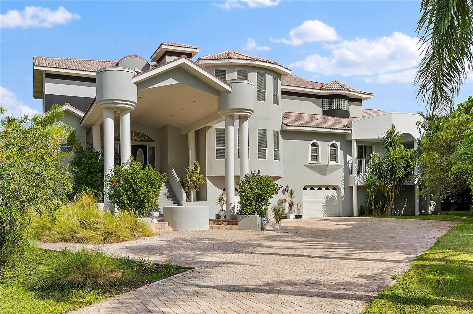 Just Listed. NEW MAJOR PRICE IMPROVEMENT. REDUCED 400K! WELCOME TO PARADISE says this high and dry majestic, elevated, custom Matta masterpiece! This beauty is located in the desired Tierra Verde on the popular Columbus Drive. This home boasts 5155 Sq Ft of total living area plus another 6000 Sq Ft of exterior enjoyment. Buyers will love the size of the 2600 sq ft of lush exterior space with excellent views of the Gulf! The Wow Garage has room for 16 CARS or all the toys, golf carts, work shop and storage area of 3424 sq ft. Upon arriving to the grand portico you will see gorgeous pavers covering 3000 sq ft with plenty of room for parking and entertaining. Once you enter the stately glass doors you will notice the soaring ceilings w open great room. There is lots of natural light throughout along with water views. The large Family Room is perfect for entertaining and features a marble clad fireplace for ambiance. The large Dining Room is just past the stunning kitchen perfect for a chef. 2 enormous islands, one for bar seating and one for cooking. More features include newer appliances, granite countertops, newer fixtures and lighting along with dining area that steps out to the covered deck for eating alfresco! The kitchen also overlooks a bright and open family room which extends the entertaining area or can be the quiet space to relax. The first floor has 3 nice sized ensuite bedrooms that have their own outdoor space to make your guests feel at home. The large laundry is also on the main level for ease. There is also a cozy loft area that has a view of the great room. There is a large 700 sq ft office that can easily be a 5th bedroom or an awesome game room. It has water so could be a wet bar, small kitchen for additional family. The owners retreat offers privacy and luxury along with a giant walk in closet. Buyers will love the walkout to the private patio and enjoy the Sunset views over the Gulf. The bath is exquisite with a palacios sunken jacuzzi tub, spacious walk in shower and double vanities. The garage is expansive and offers so much space for cars and toys it will be the envy of all your friends in this perfect man cave garage. This 1/3 acre lot is located on the West side but is still off the water. It has plenty of space to build the pool/backyard of your dreams. The new owners will love living in Tierra Verde with the nearby marina, restaurants, shops and quiet, peaceful, tropical amenities that is has to offer. It is close to Fort De Soto State Park and minutes to all of the beaches in the area. It is 15 minutes to downtown St Pete and everything it has to offer including the Pier, Museums, Restaurants, Bars & Parks along the waterfront. This home is only 30 minutes from the airports and quick to the Skyway Bridge. Welcome to Paradise with this absolute beauty and best of all buyers will Love the New Price!