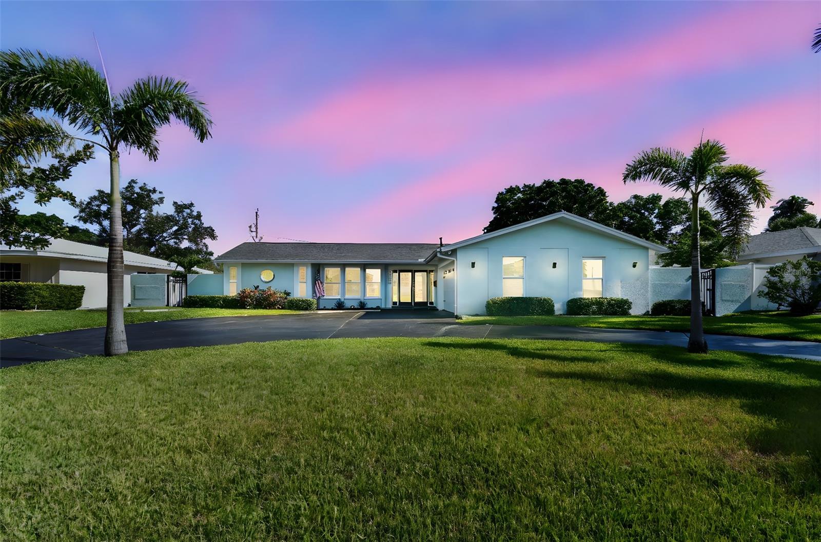 Welcome to a meticulously reimagined St. Petersburg residence where refined updates meet everyday livability. Elevated over 11 feet above sea level and located in Flood Zone X, this home not only boasts peace of mind, but also exceptional craftsmanship. From newer impact-rated windows and doors to luxury finishes throughout, every inch of this property reflects intentional design. Newer ductwork and a thoughtful blend of interior and exterior enhancements make the home as resilient as it is beautiful.
Perfectly situated just one mile from Maximo Park—offering boat, jet ski, kayak and paddleboard launch access, walking trails, a frisbee golf course and beach—the home is also minutes from Fort DeSoto, award-winning St. Pete Beaches, Interstate 275 and Downtown St. Petersburg.
Step inside to an open living area with water views of Tampa Bay and a stunning custom kitchen featuring Cambria quartz countertops, solid wood cabinetry, a natural gas stove and newer appliances. The west wing hosts the light-filled primary suite with French doors leading to the pool, a spa-like ensuite with double vanity and oversized walk-in shower. A generously sized guest bedroom, also in the west wing, offers abundant natural light and flexibility. The east wing provides two additional bedrooms, including one with French doors opening directly to the pool area, a full guest bath, and a laundry room with matching cabinetry conveniently located just off the garage and leading into the main living space. Luxury tile flooring extends throughout the entire residence for a cohesive and elevated look.
The newly refinished pool and deck are complemented by an updated screen enclosure and a fully landscaped, tropical-style yard that evokes a private oasis. Expansive outdoor living space includes a covered patio with a dedicated hookup for a natural gas grill, perfect for alfresco dining and entertaining. The garage has been partially converted to an air-conditioned flex space ideal for a gym, studio or office, while still accommodating storage. A resurfaced driveway and freshly painted front door complete this polished presentation.
Whether drawn to its storm-ready construction, standout finishes or enviable location, this residence offers an exceptional lifestyle—designed for peace of mind, elevated living and lasting value.
Qualified buyers may receive a 1-year interest rate buydown for the first year paid for by the Seller's preferred lender when financing this home (subject to credit approval and program availability) - call today for details.