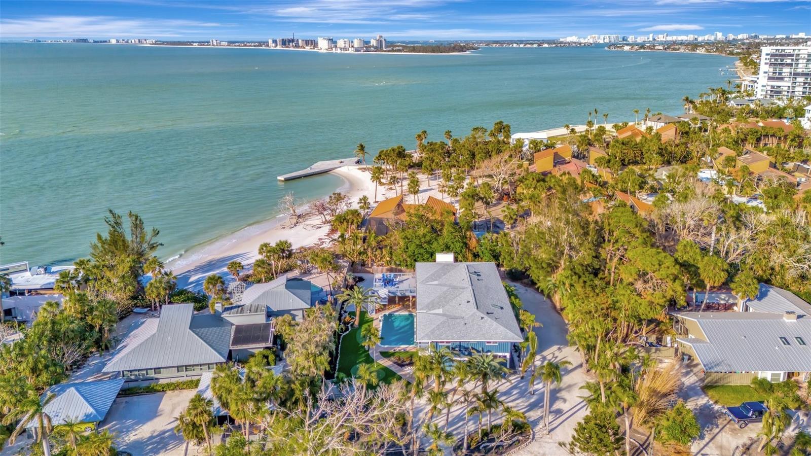 Stunning Gulf of Mexico views from the living room, dining room, kitchen, primary bedroom and office make this a magical place. The multi-level decks and outdoor seating areas are an incredible place to view the gulf and watch sunsets and dolphins. Located in the Sandy Hook community with a private shared beach, the home is walking distance to the Siesta Key Village with its fantastic restaurants, shops and wine bar. The home is situated on .52 acres with 3 ensuite bedrooms plus an office which could serve as an additional bedroom. The first floor has a 3 car garage, bonus room and a guest suite with a full bath and kitchenette. The three hole mini golf course in the backyard and large swimming pool make this a perfect house for entertaining. There is also an exterior elevator.