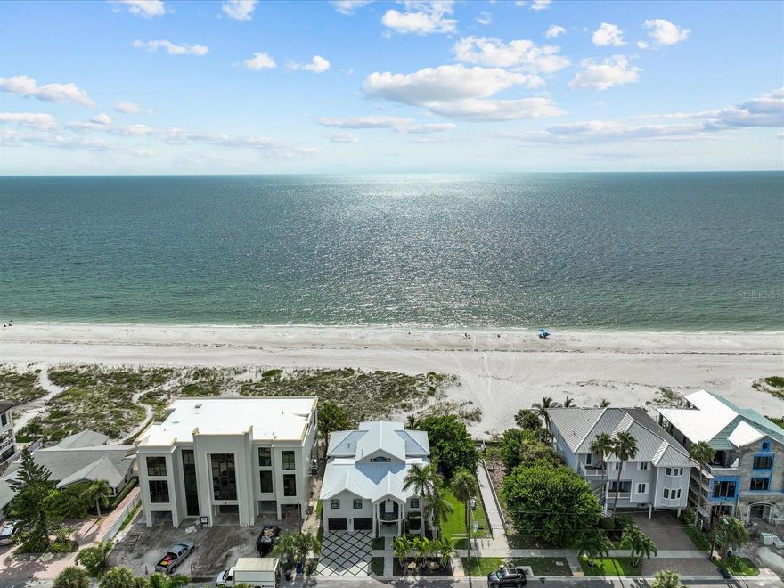 EXCEPTIONAL BEACHFRONT LIVING | 60 FEET OF DIRECT GULF FRONTAGE | EXTENSIVELY RENOVATED

Welcome to your private slice of paradise on Clearwater Beach — a move-in ready, fully renovated 5-bedroom, 5-bathroom coastal retreat offering breathtaking views, unforgettable sunsets, and the kind of beachfront lifestyle that brings families together for generations.

From morning walks along the sand to holiday dinners with your feet in the surf, this home offers more than luxury — it’s a destination for connection. With 60 feet of direct Gulf frontage and expansive views from both levels, you’ll enjoy unobstructed vistas of the water from nearly every room.

Inside, the open-concept layout is ideal for gathering — featuring a designer kitchen with marble countertops, high-end appliances, and a spacious dining and living area anchored by a dramatic water vapor fireplace. With 10+ TVs, a billiards room, and a dedicated office, every space has been curated for both comfort and entertainment.

Whether it’s morning walks along the shoreline, sun-soaked afternoons by the pool, or evenings spent exploring Clearwater’s vibrant dining scene, this home offers the full Florida lifestyle — relaxed, refined, and made for memories.

Step outside to your private backyard oasis — complete with a heated spool (spa/pool combo), built-in fire pit, lush tropical landscaping, and elegant gas lantern lighting. Whether you’re sipping cocktails at sunset, toasting marshmallows under the stars, or watching your kids play in the sand just beyond your gate, this home is made for making memories.

Additional highlights include:
 • 2-story floor plan with Gulf views from both levels
 • 10+ TVs included 
 • Spool with hot tub & gas heater
 • Fire pit for evening relaxation
 • Deeded boat slip & furnishings negotiable
 • Professionally landscaped grounds with multiple outdoor living spaces

Important Note: This home sustained no interior water damage from recent storms.

Beachfront homes of this quality — especially those turnkey, tastefully renovated, and designed for multigenerational living — are rarely available in Clearwater Beach. Schedule your private showing today and envision the holidays, sunsets, and lasting memories that await.
